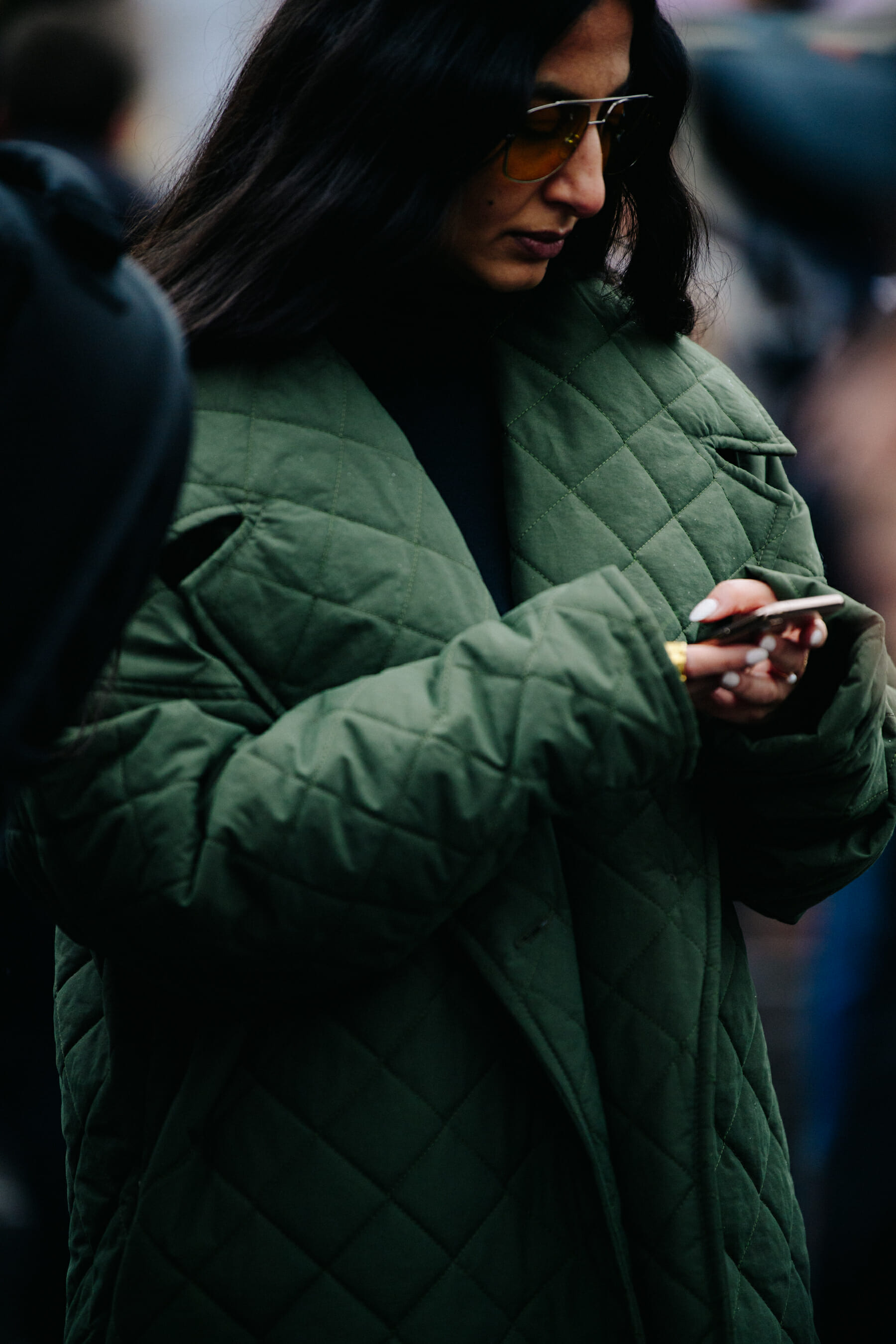 Woman wearing green quilted jacket