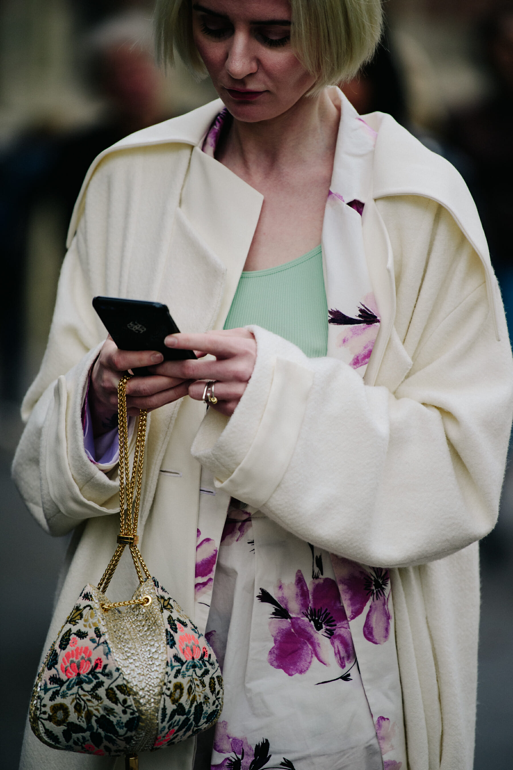 Woman wearing white floral coat