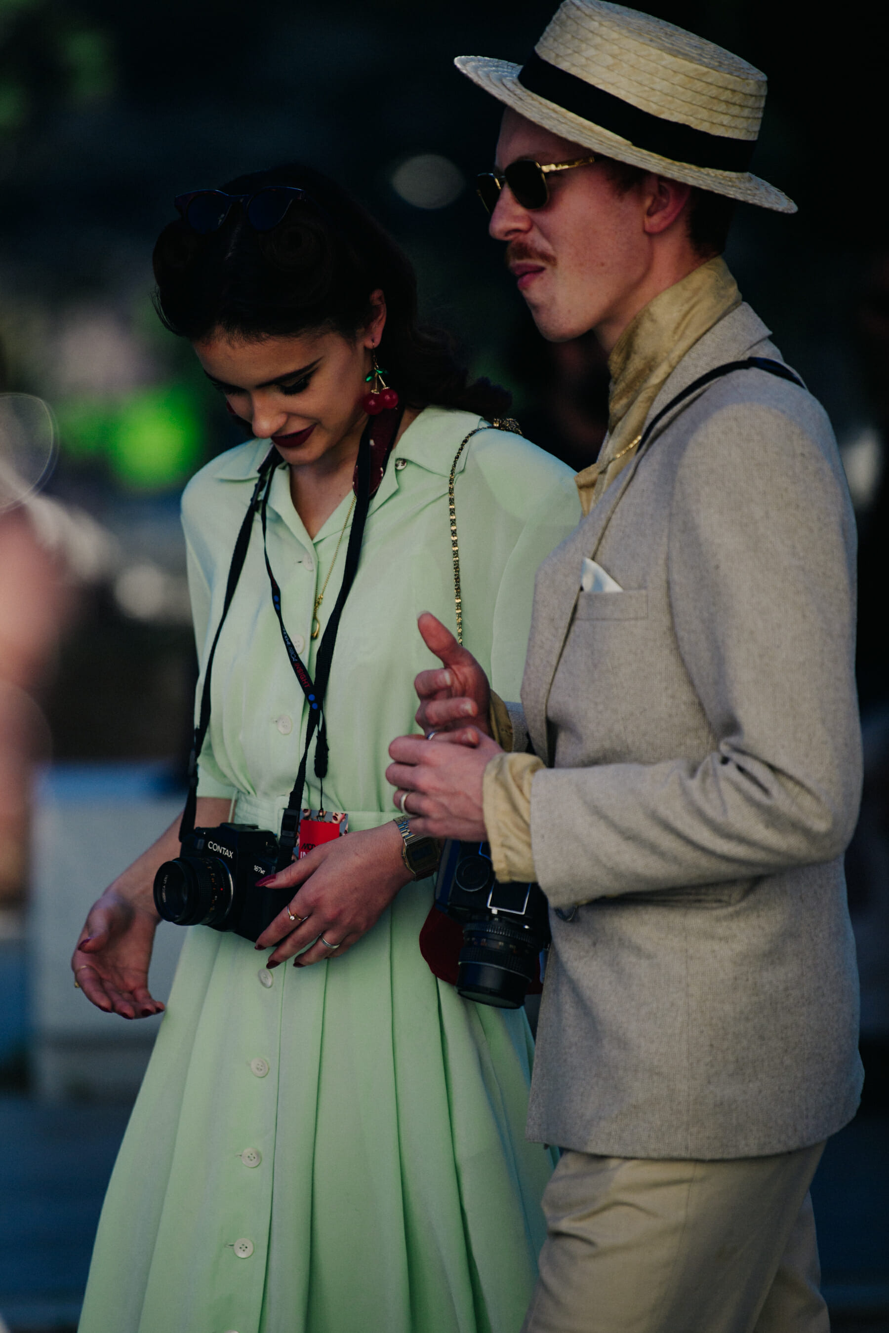 Couple carrying vintage cameras