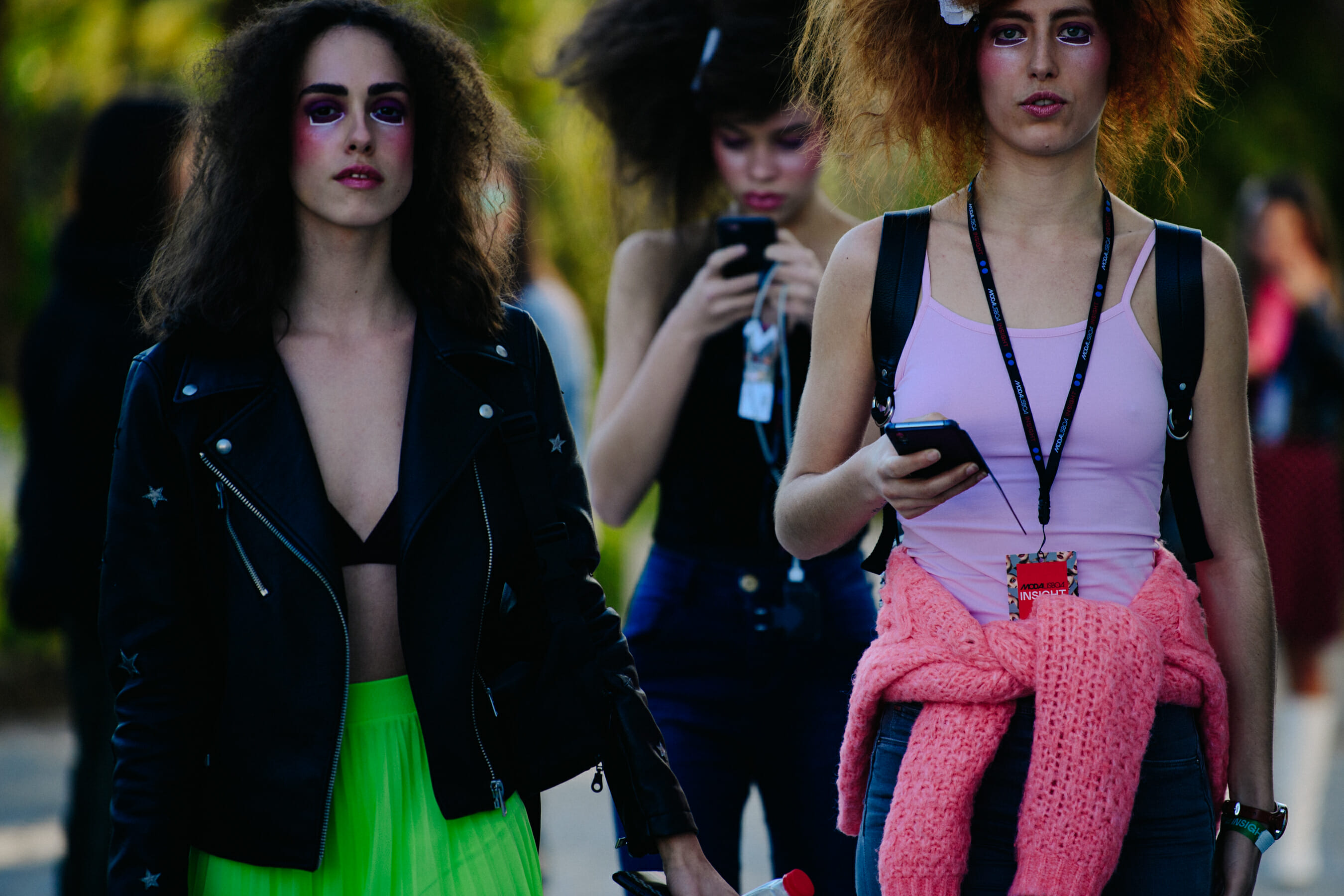 Two models wearing pink and green