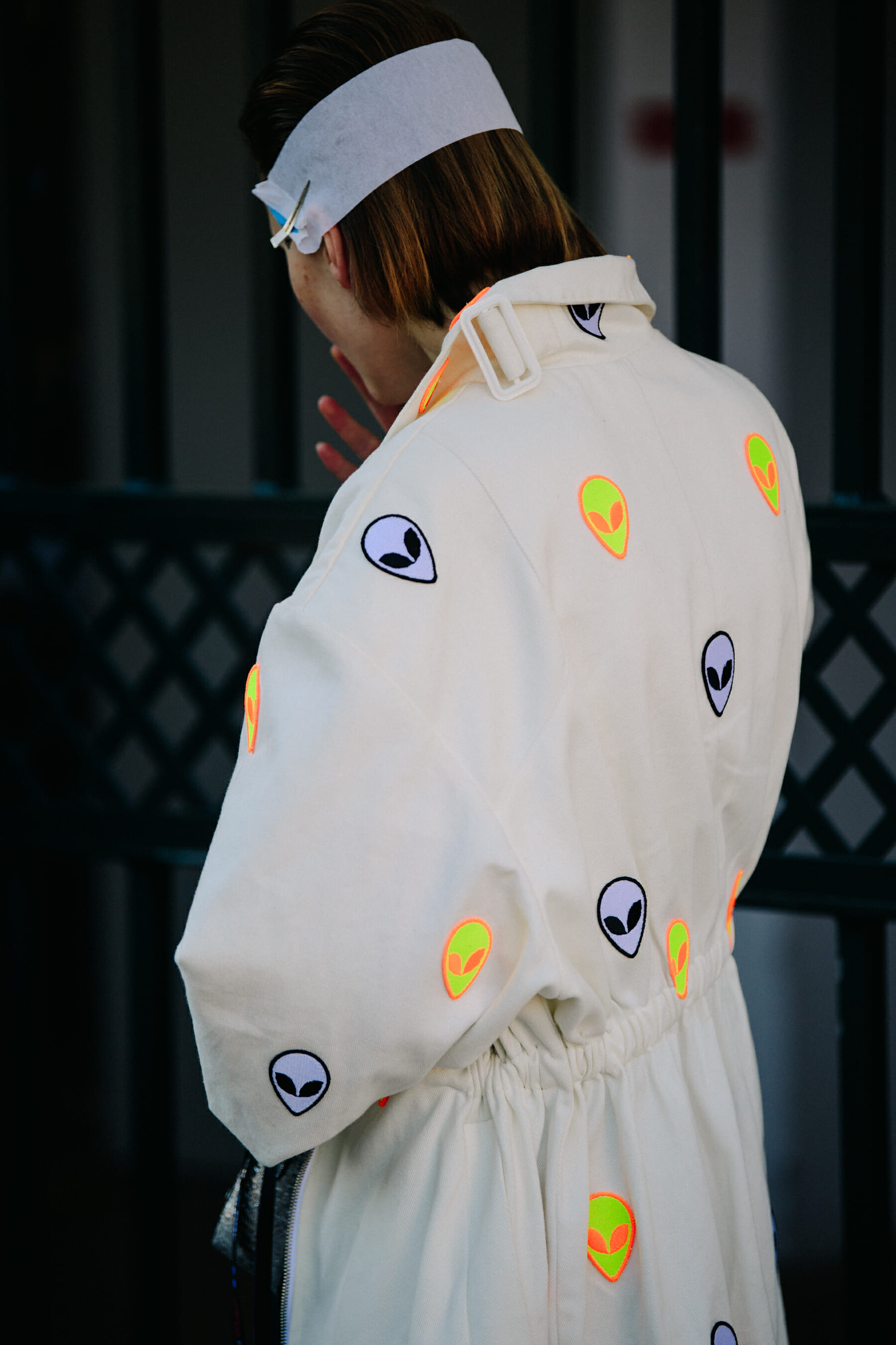 Woman wearing alien print coat