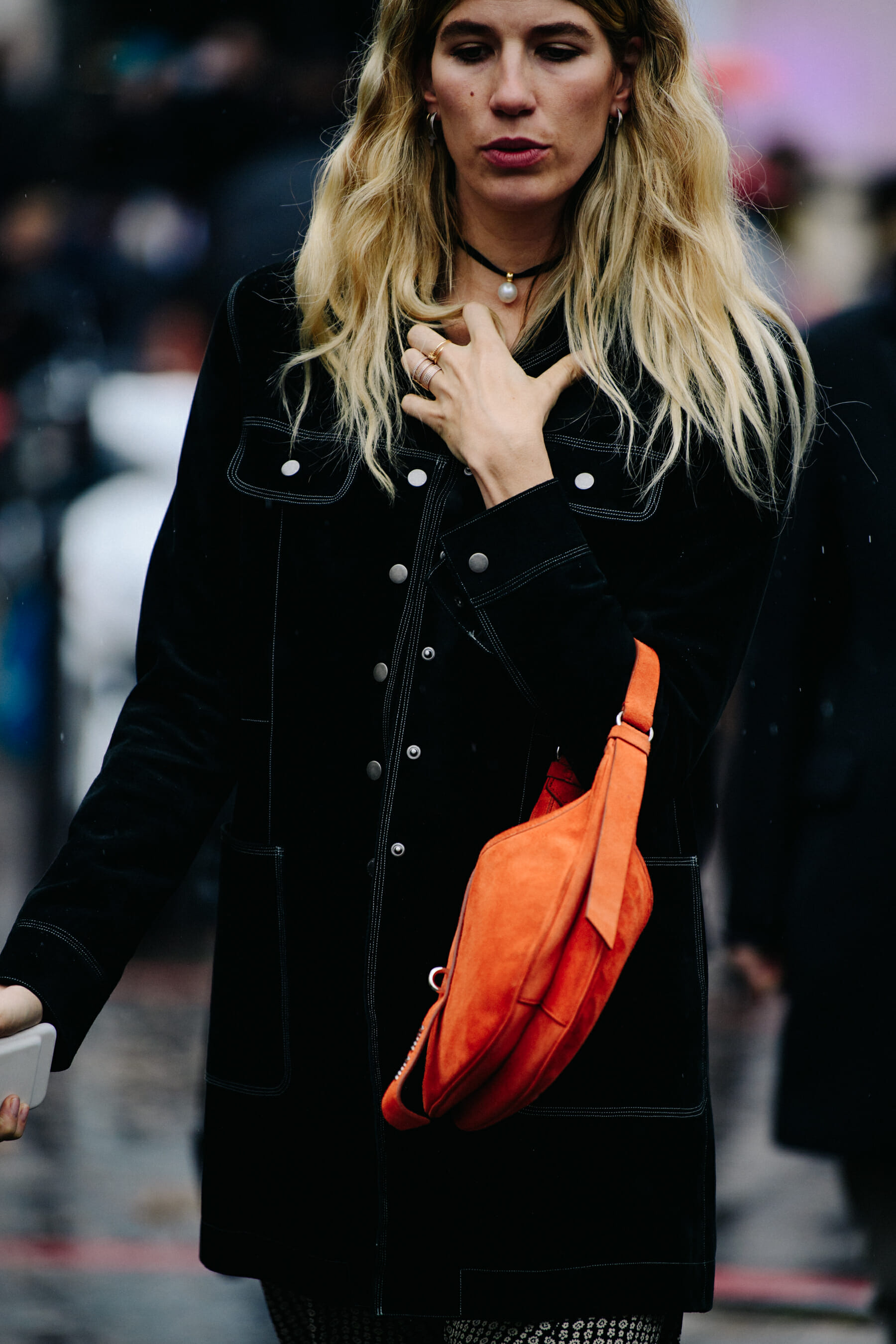 Woman carrying orange leather bag