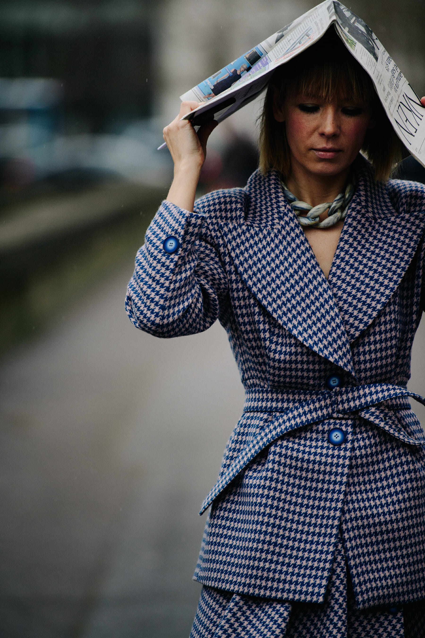 Woman carrying newspaper on head
