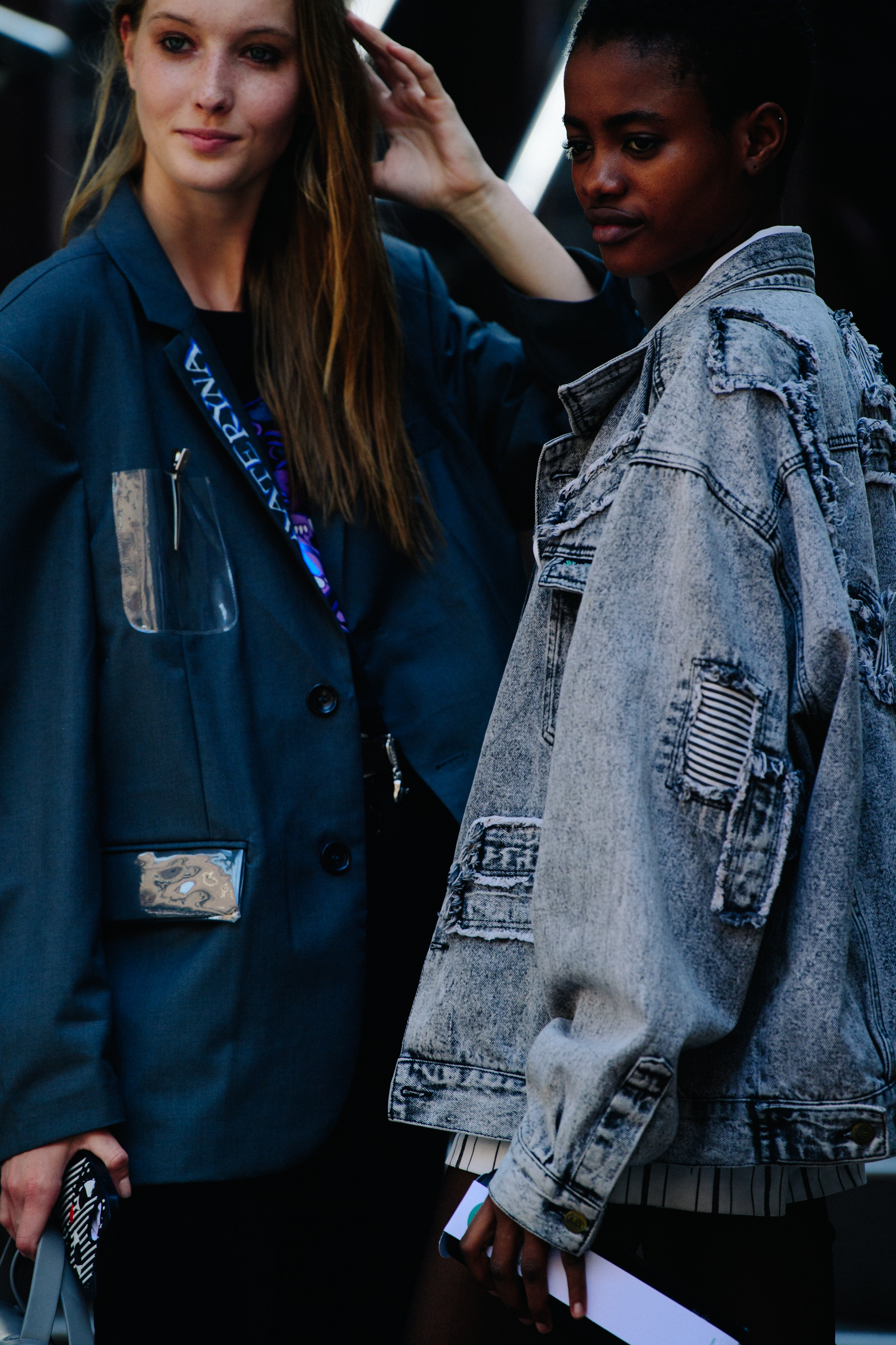 Two women wearing light jackets