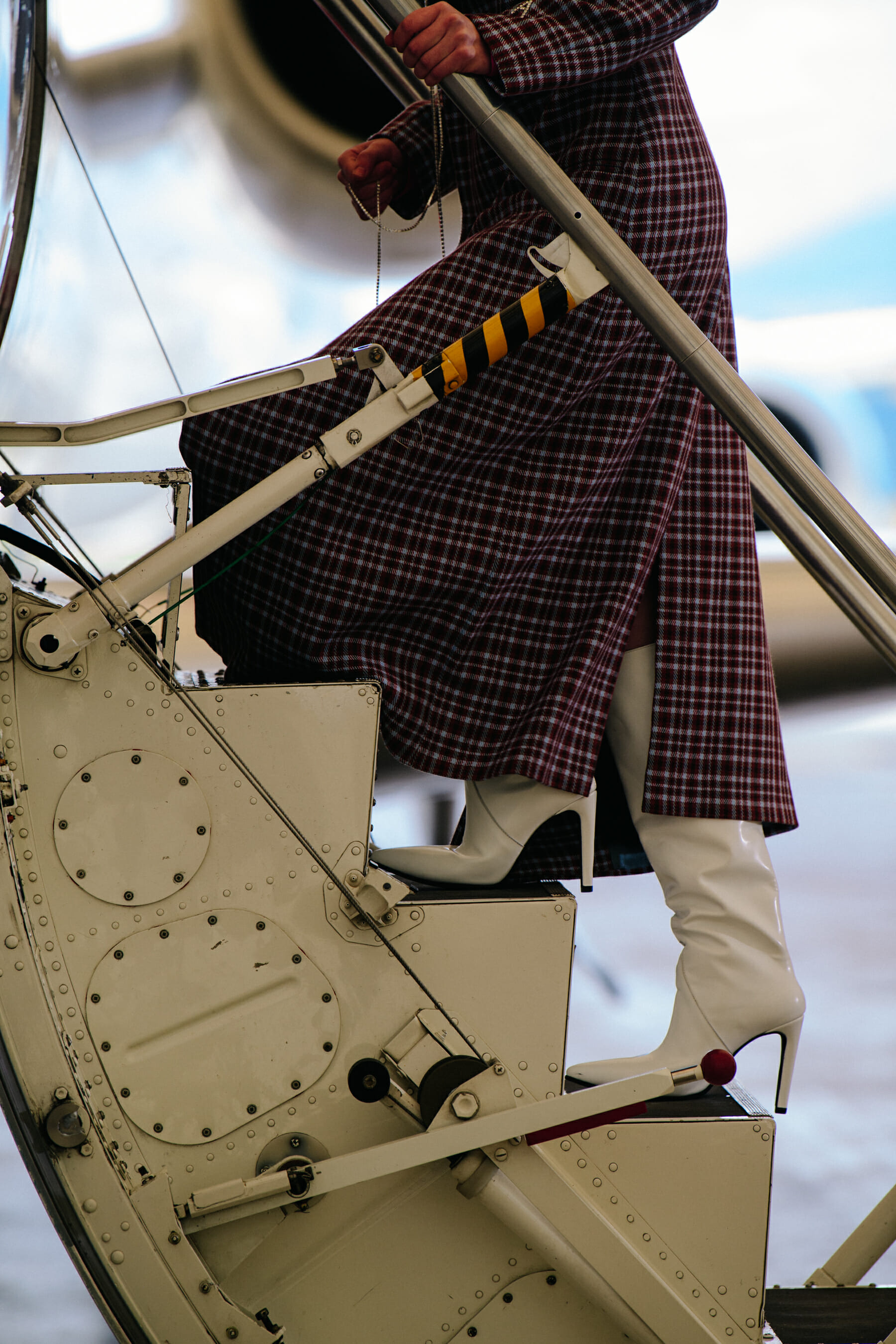 Model wearing check coat