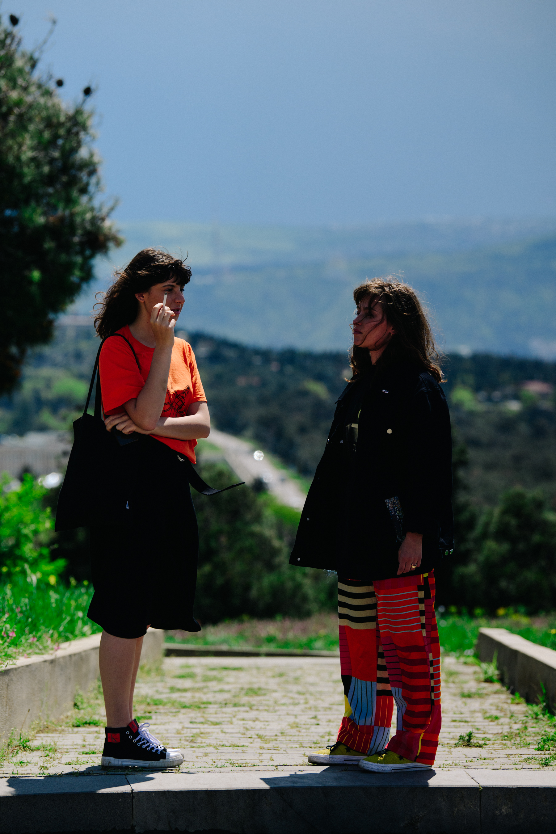 Two women wearing orange clothing