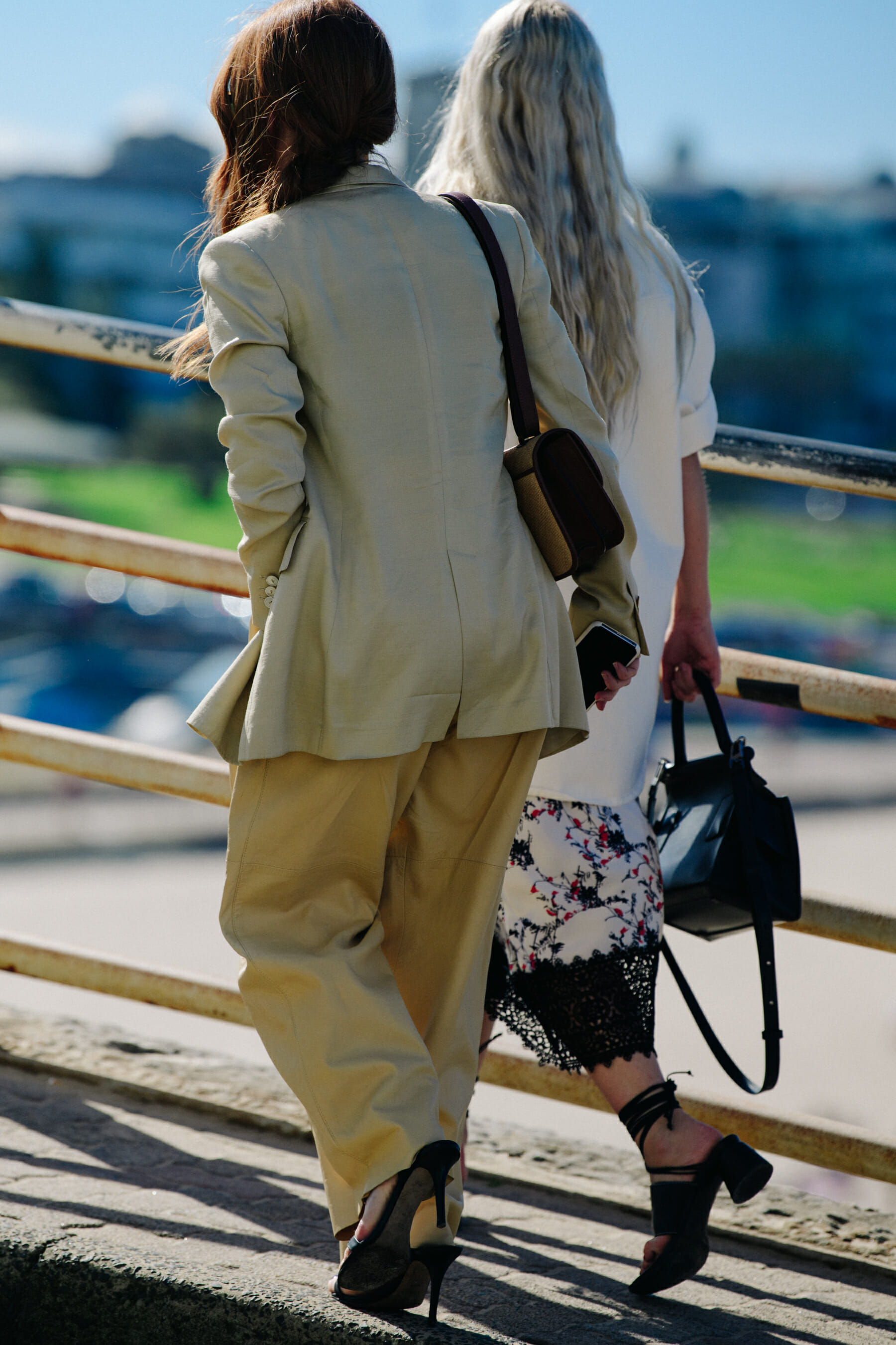 Two women wearing light outfits