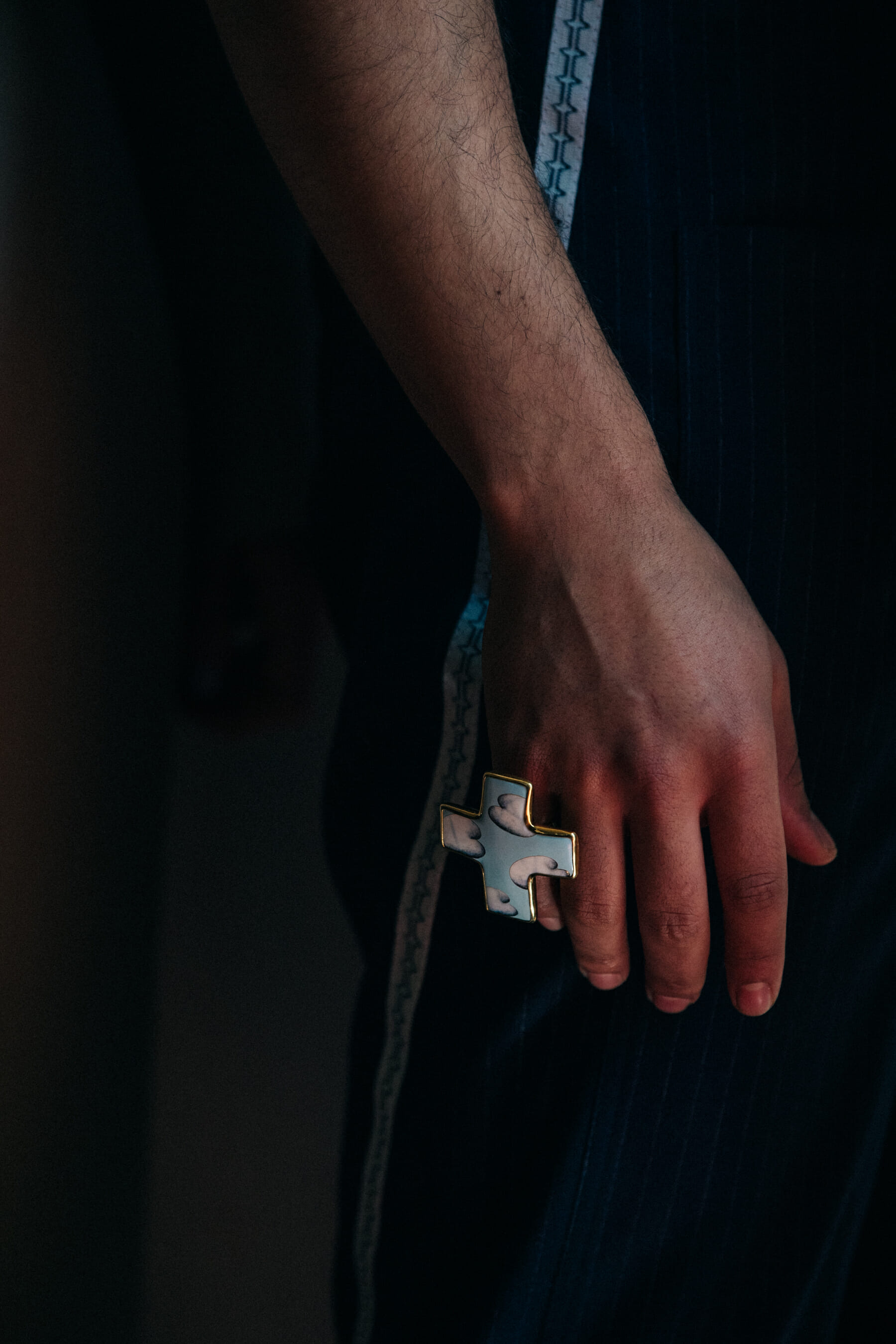 Model wearing cross ring at Situationist