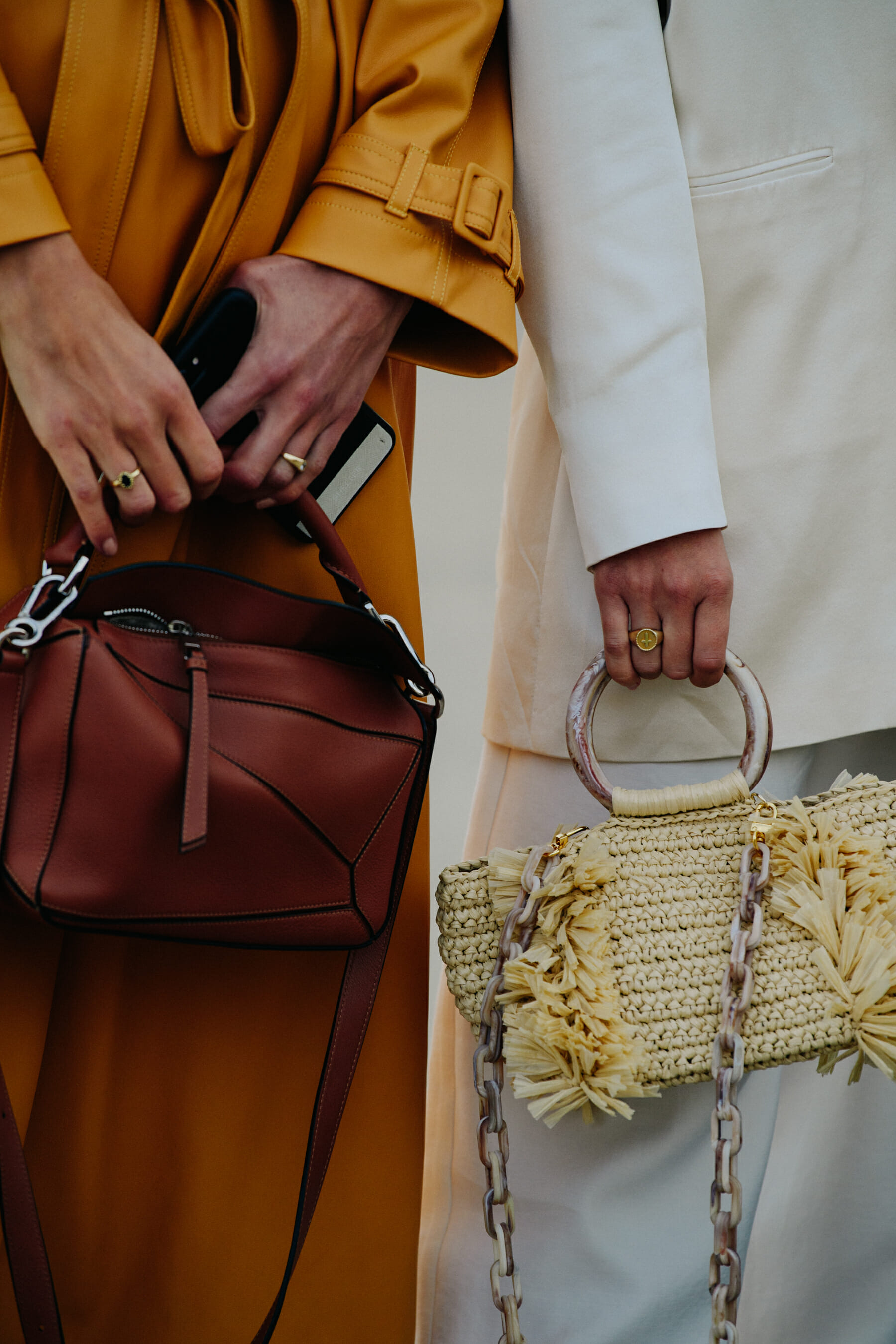 Two women carrying designer bags