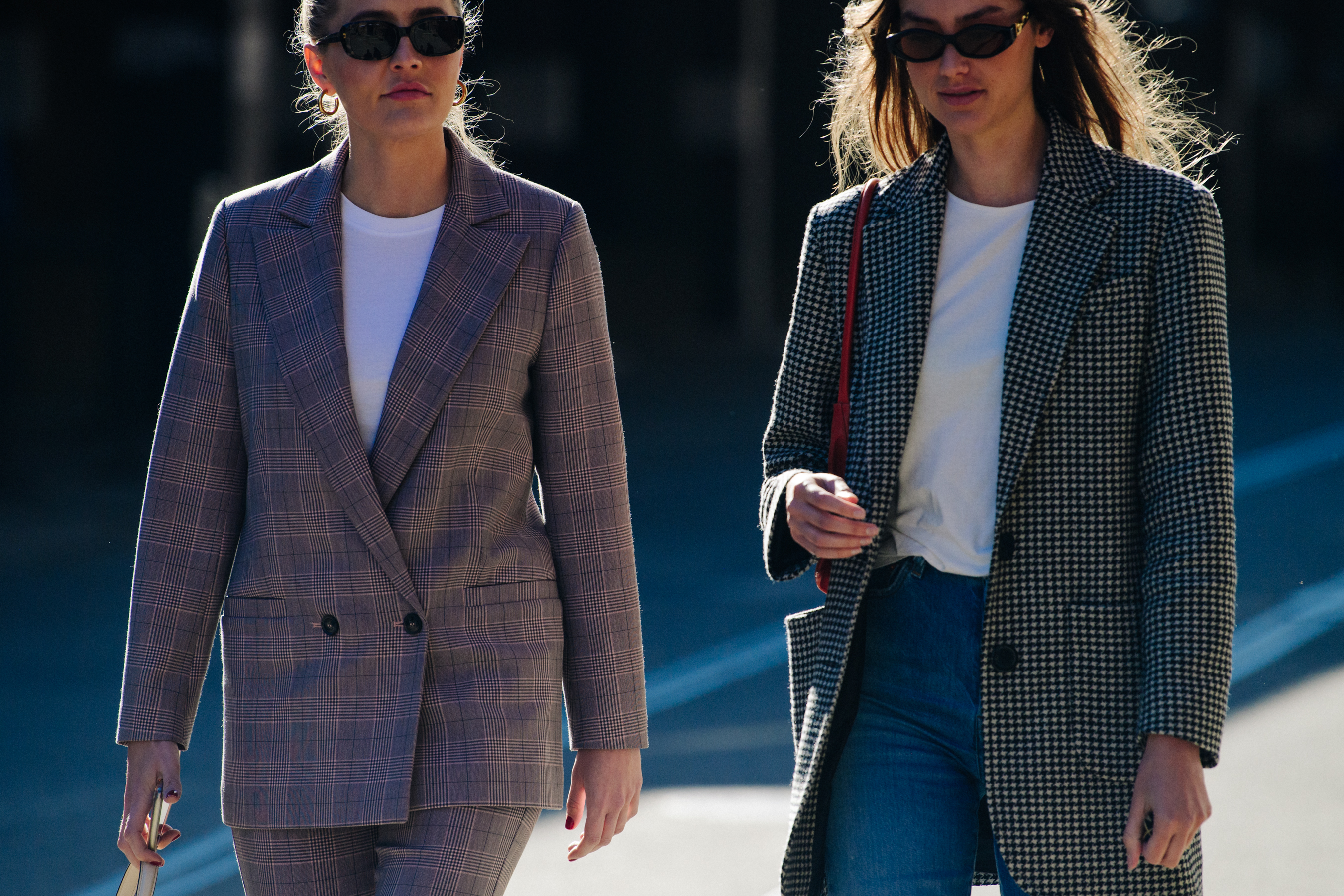 Two women wearing check tops
