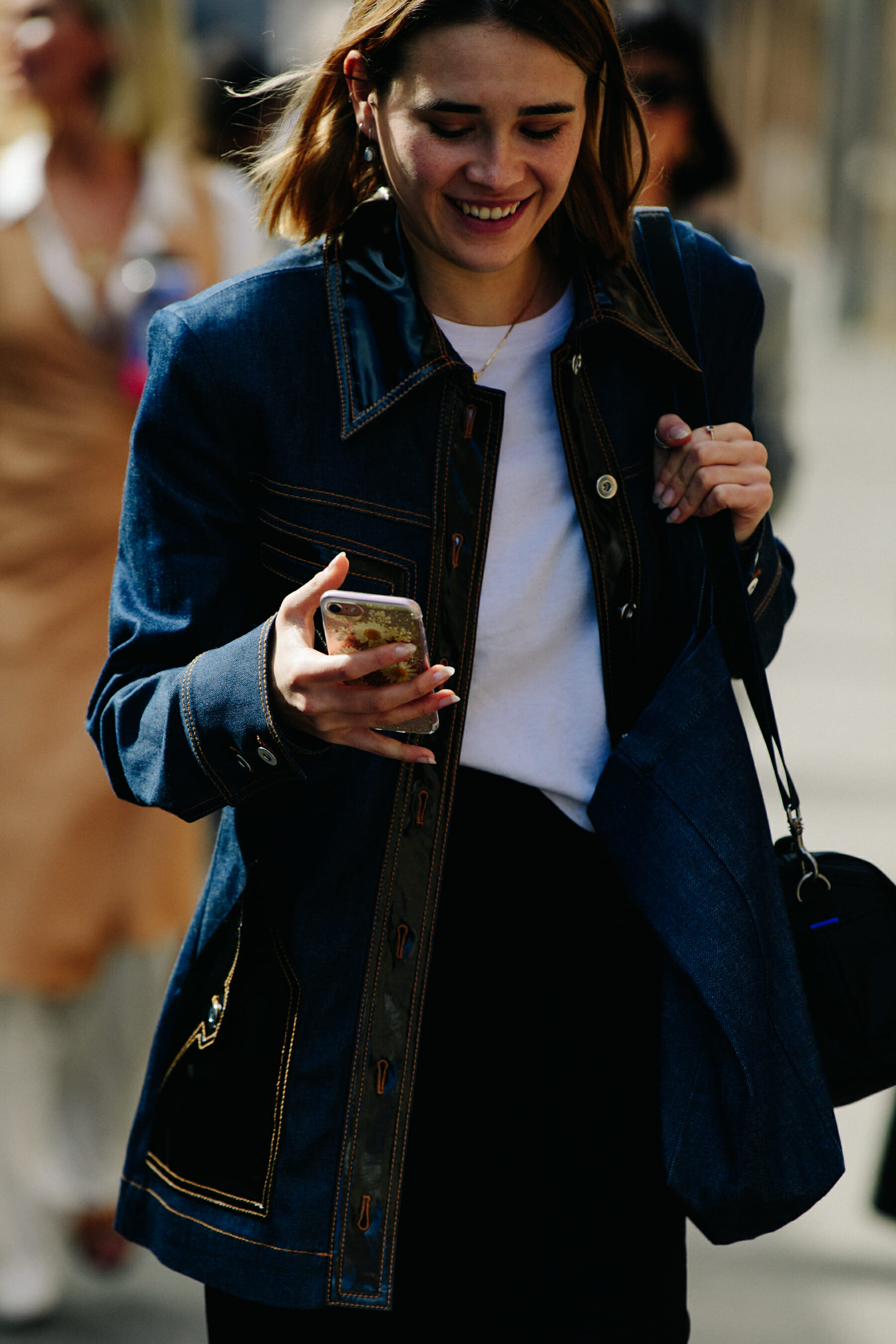 Woman wearing long denim jacket