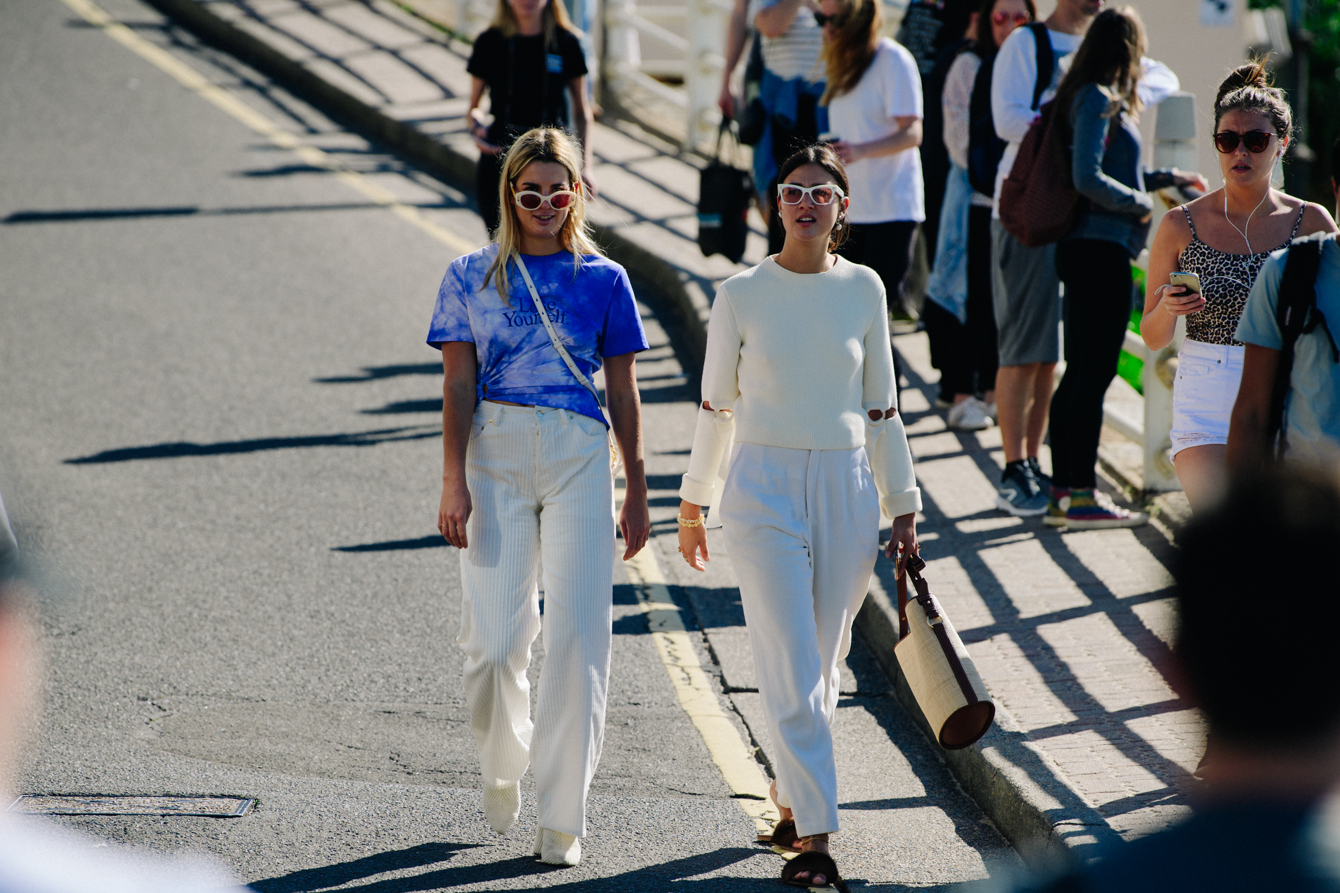Two women wearing light outfits