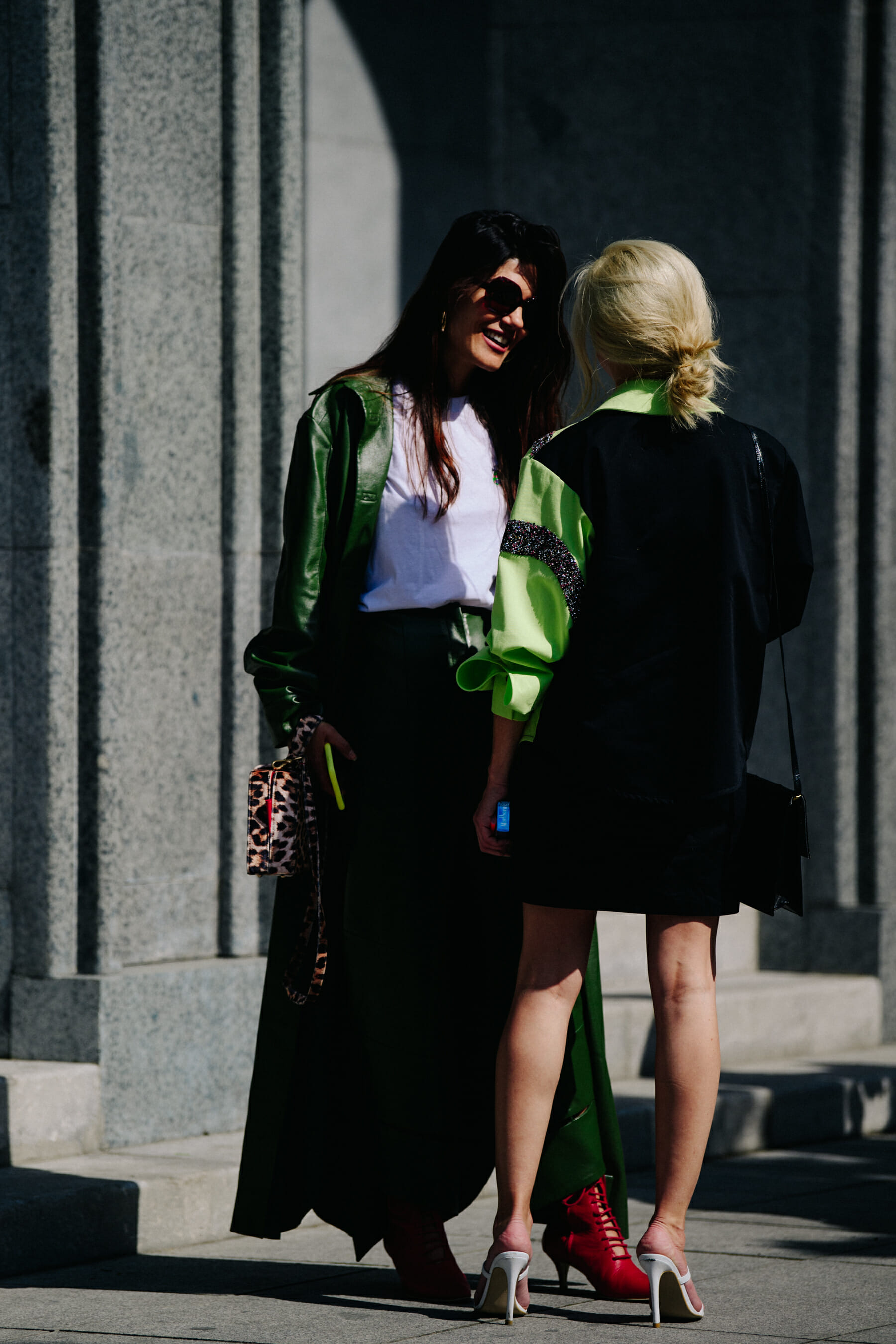 Two women wearing green