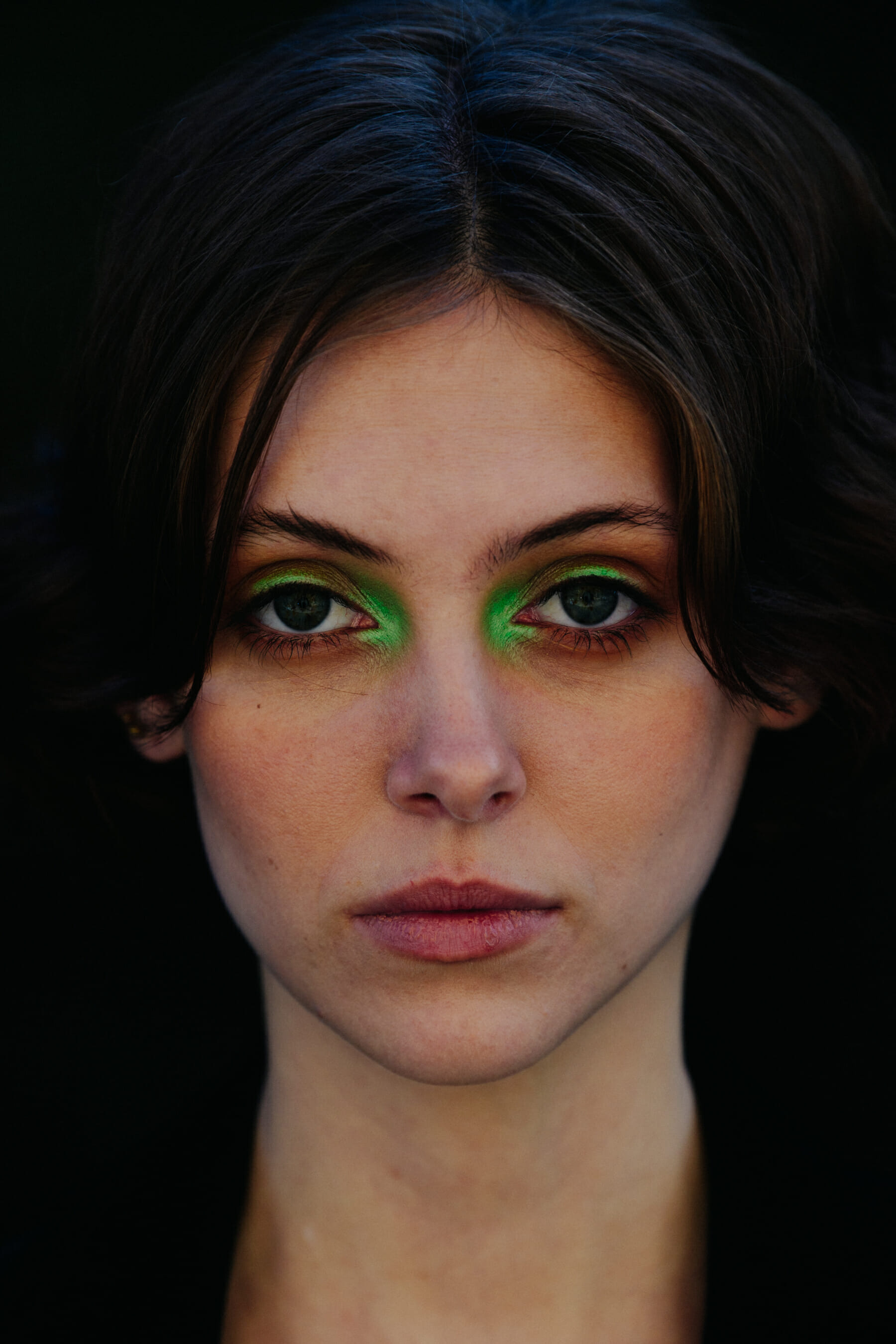Portrait of model wearing green eye makeup