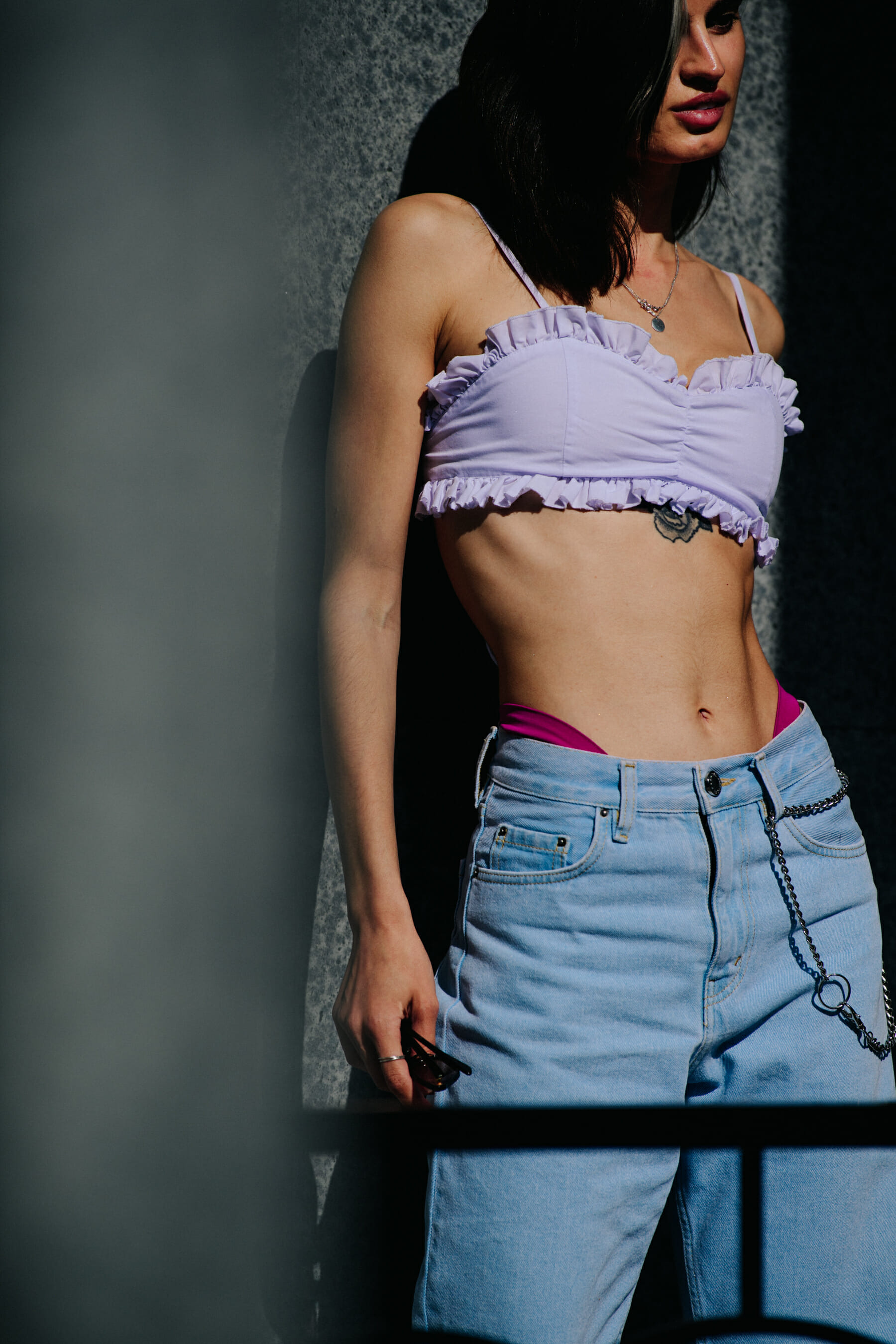 Model wearing white top
