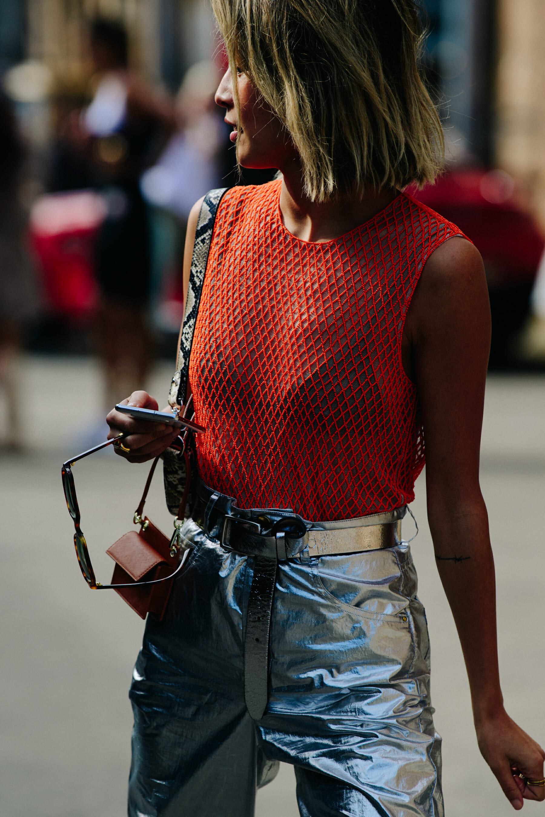 Blogger wearing orange net vest