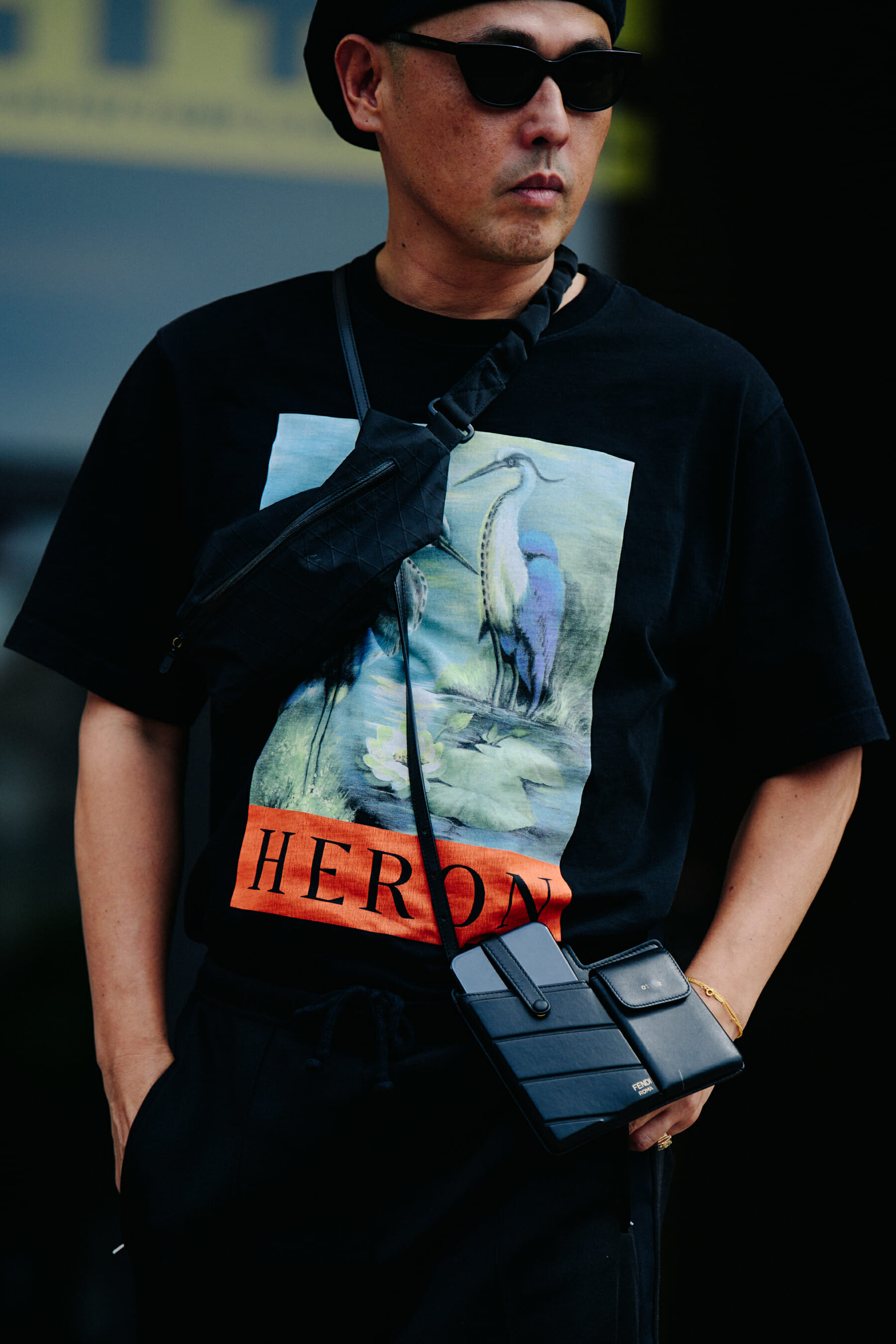 Man wearing black Heron Preston tee shirt