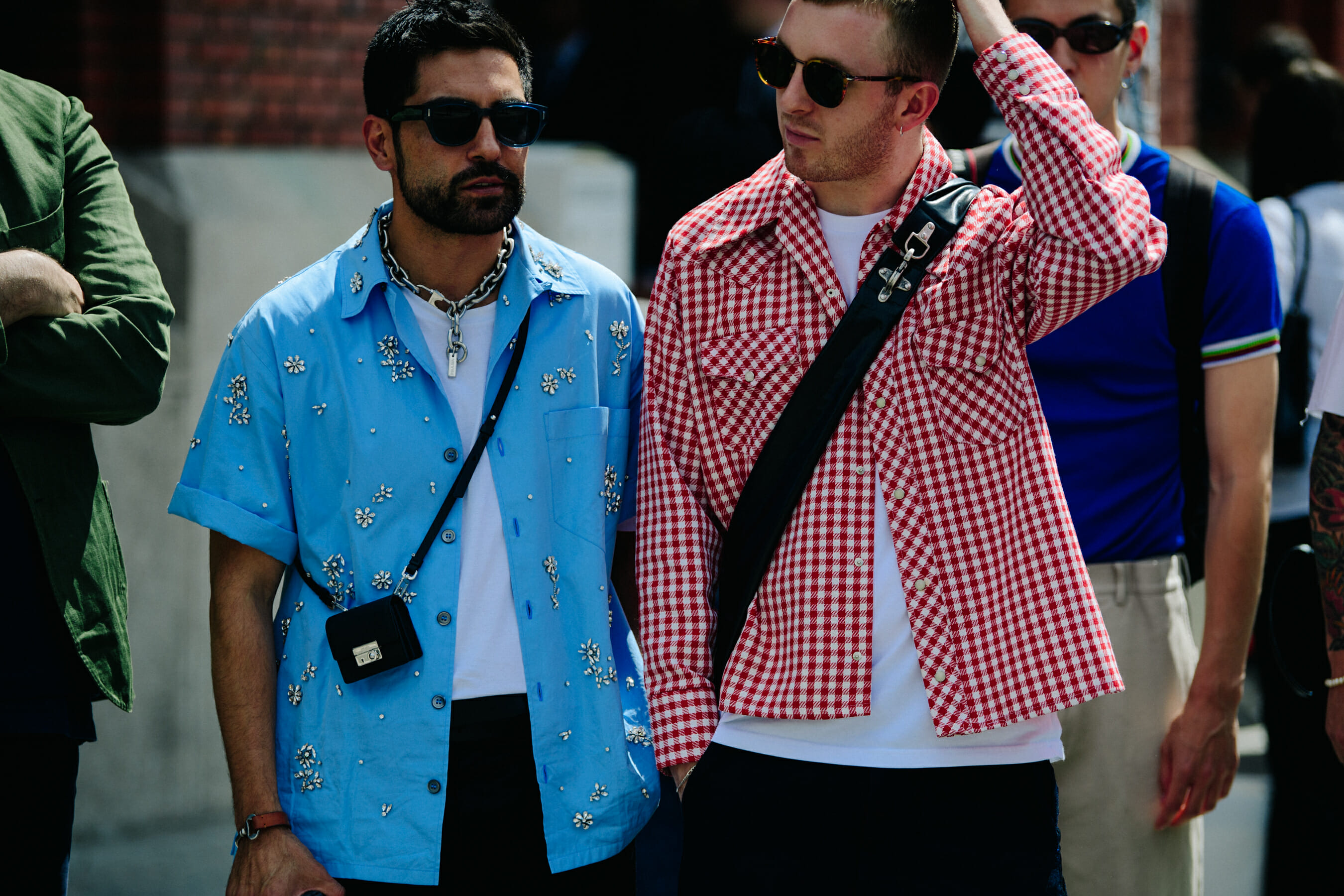 Two men wearing blue and red shirts