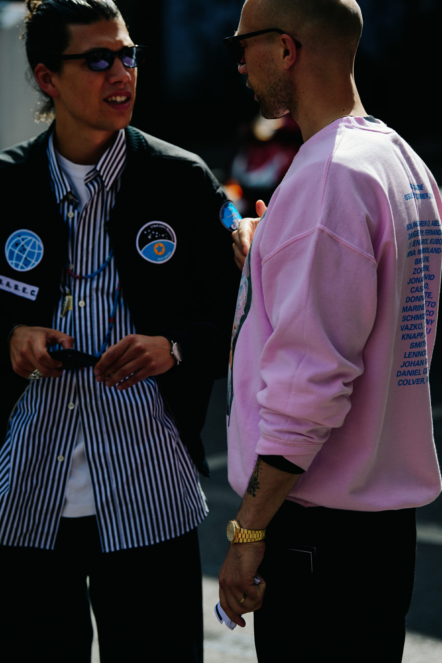 Two men wearing pink and blue