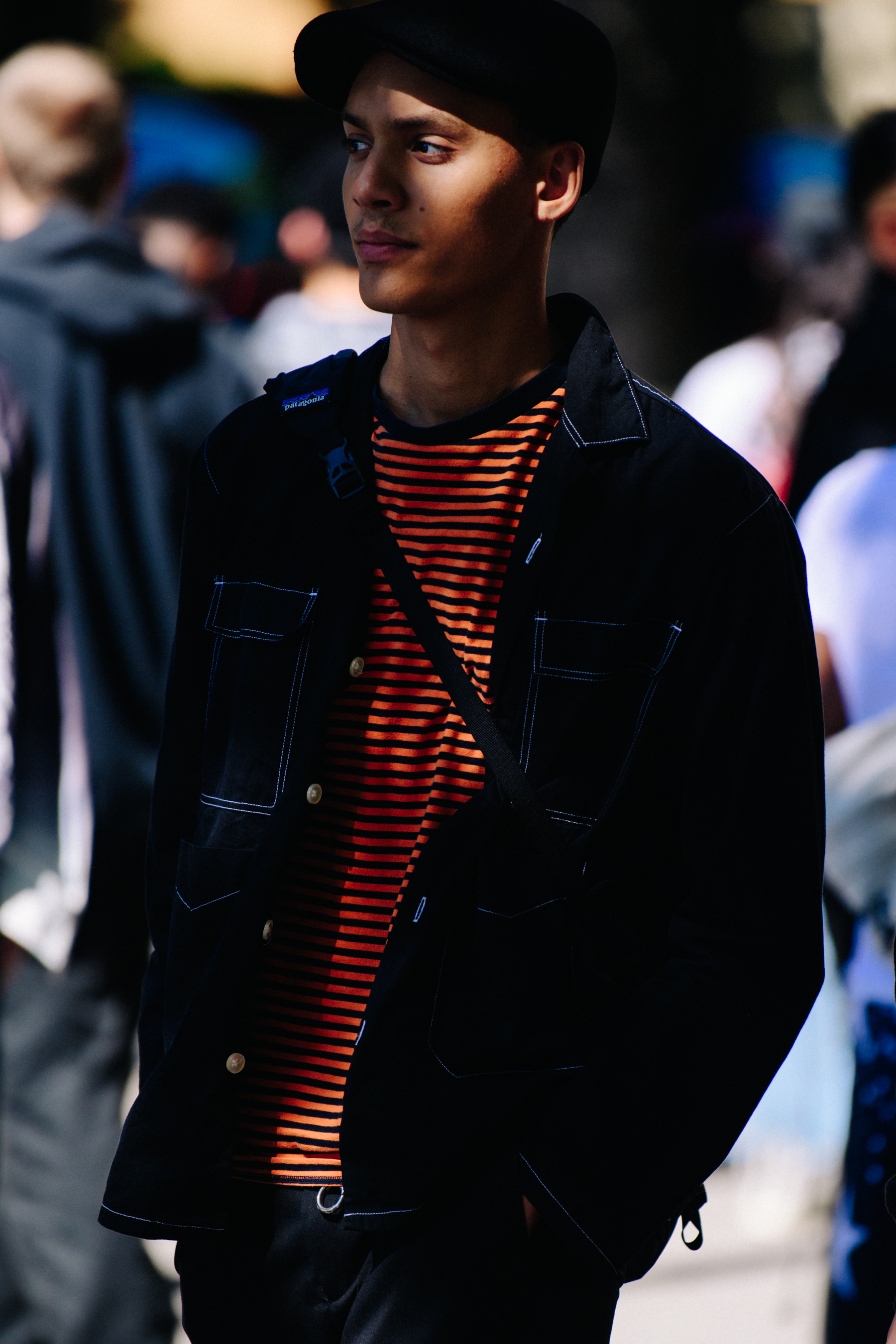Man wearing striped orange tee