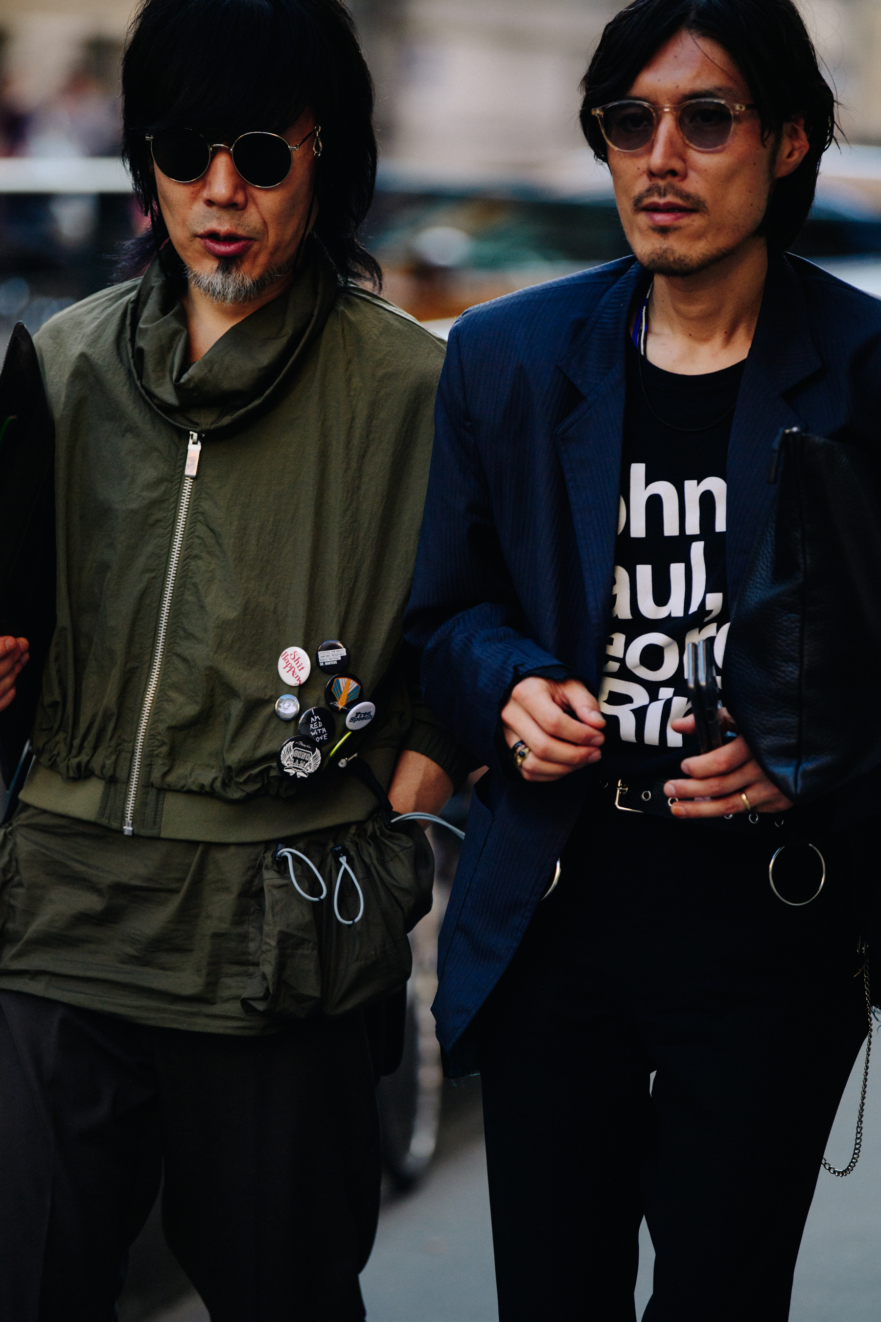 Two men wearing green and blue jackets