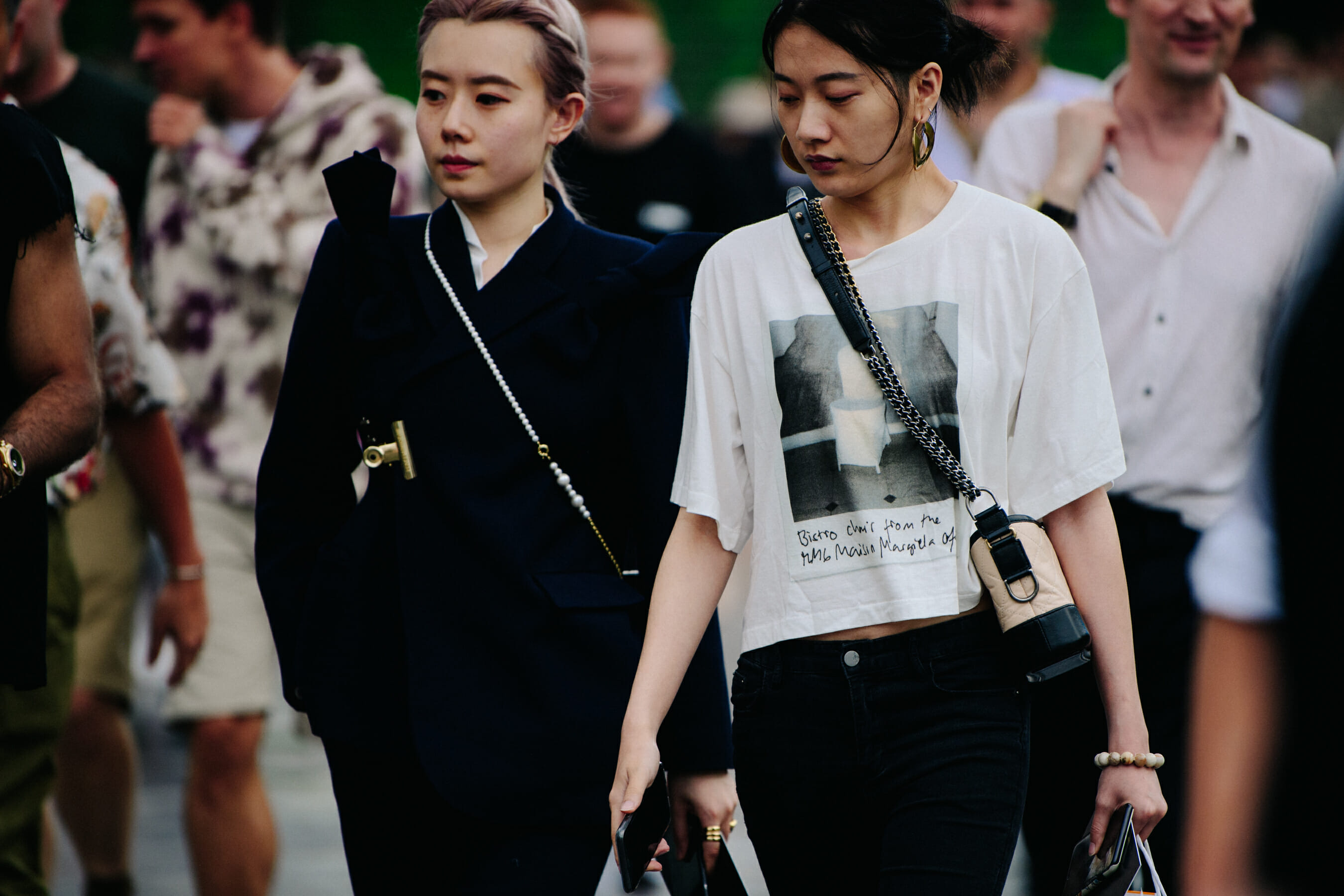 Two women wearing white and black