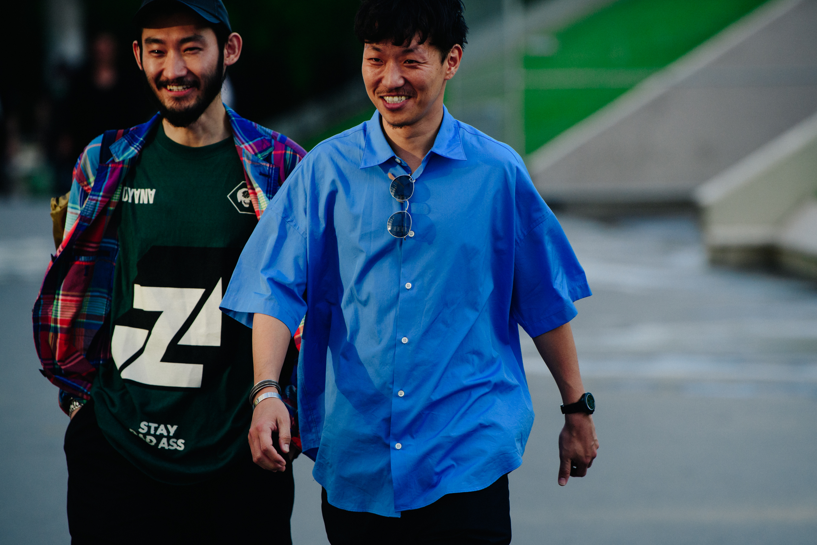Two men wearing blue and green