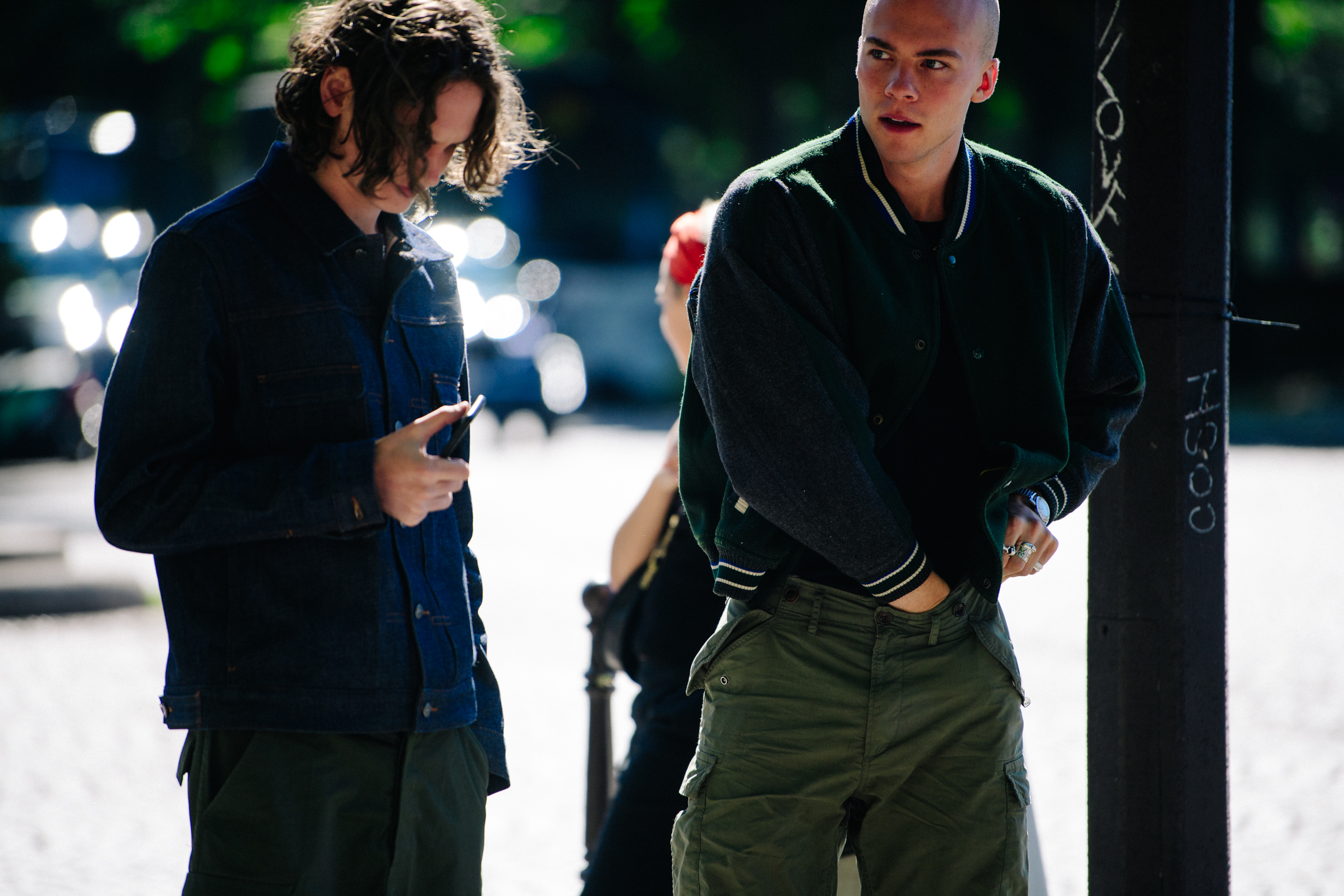 Two men wearing dark outfits