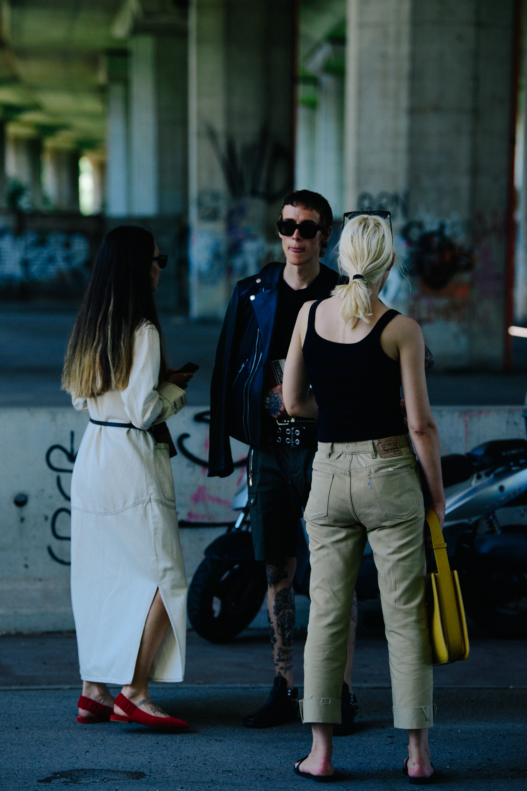 Three people wearing tan and black