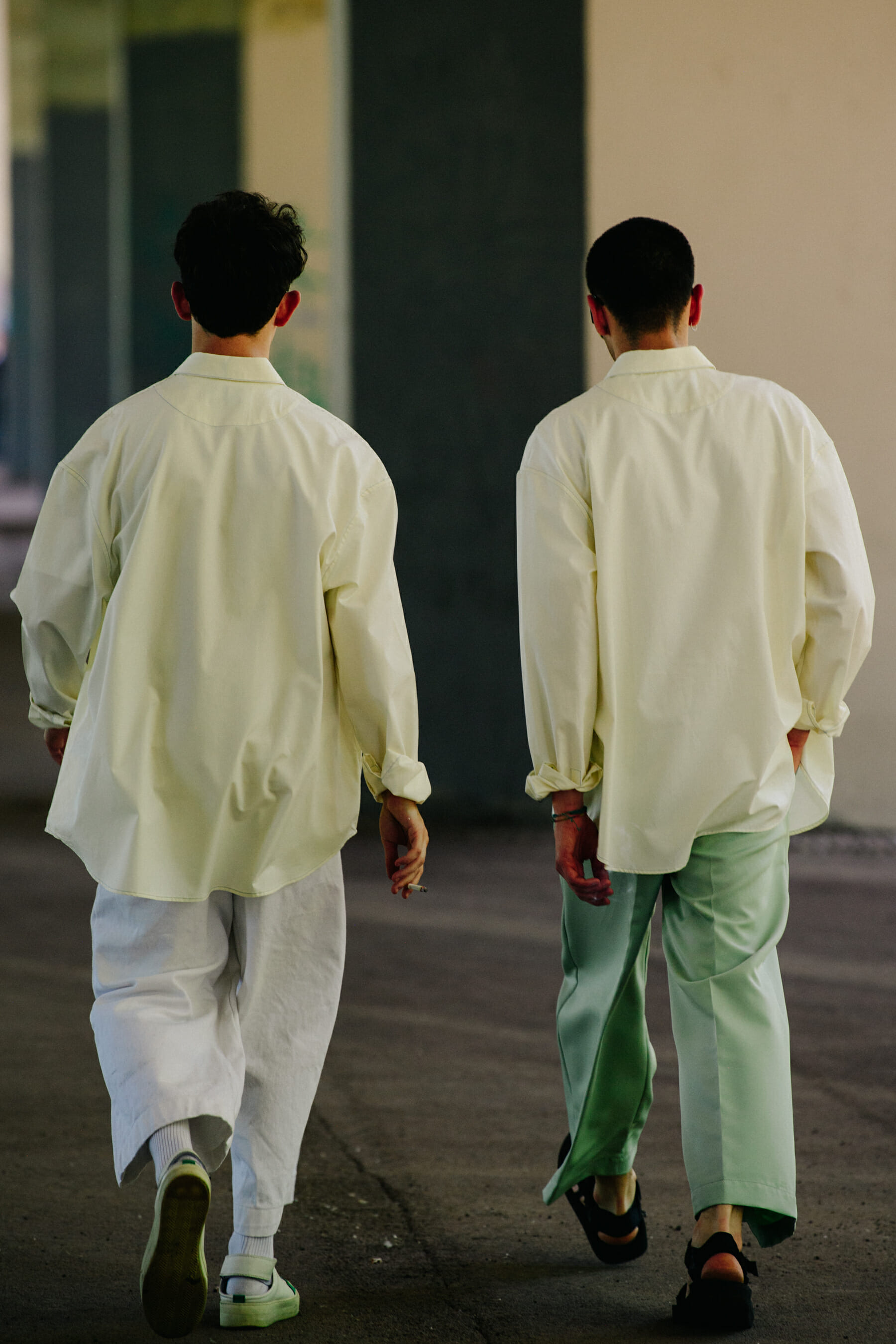 Two men wearing yellow shirts