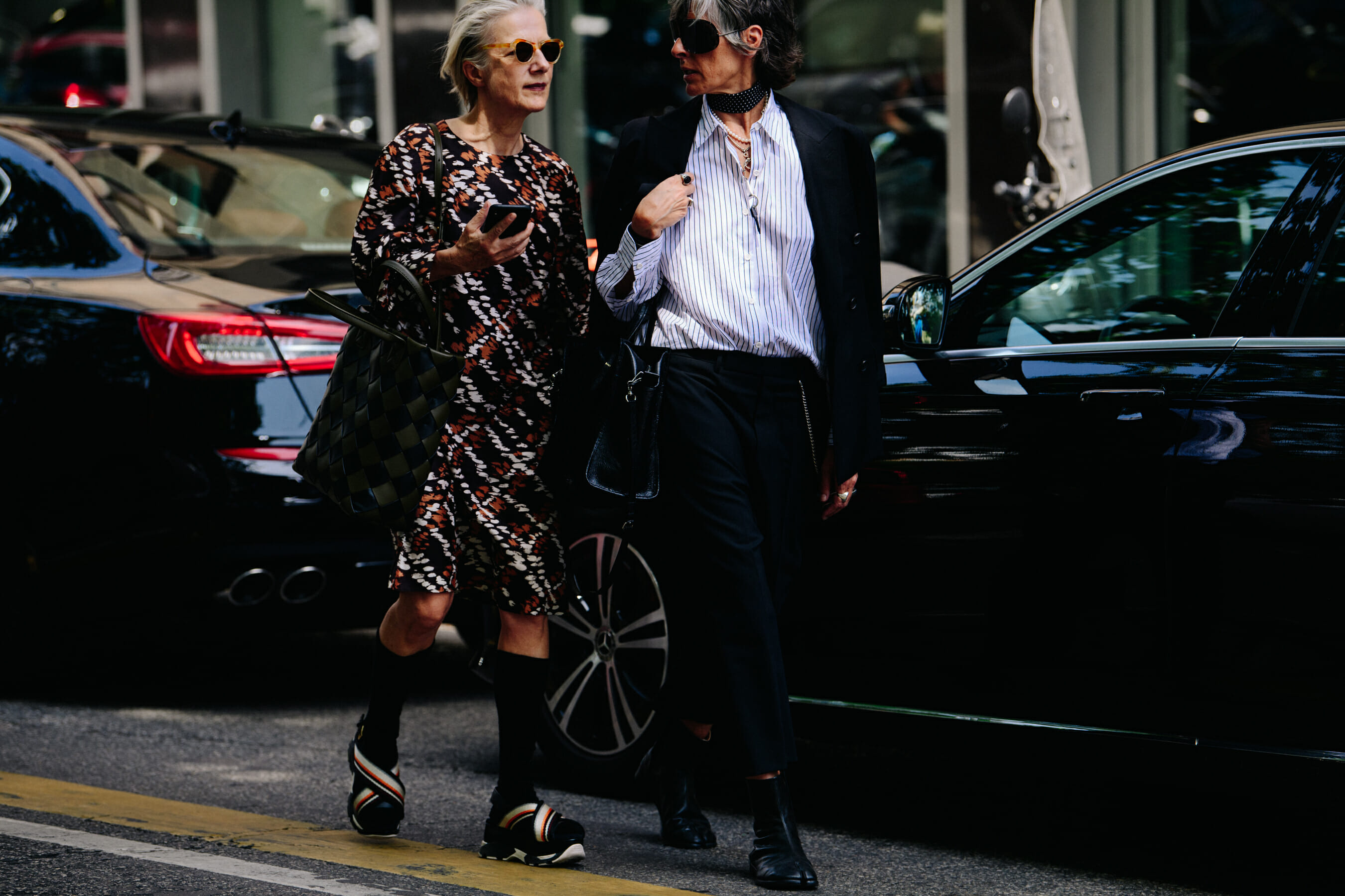 Two women wearing smart outfits