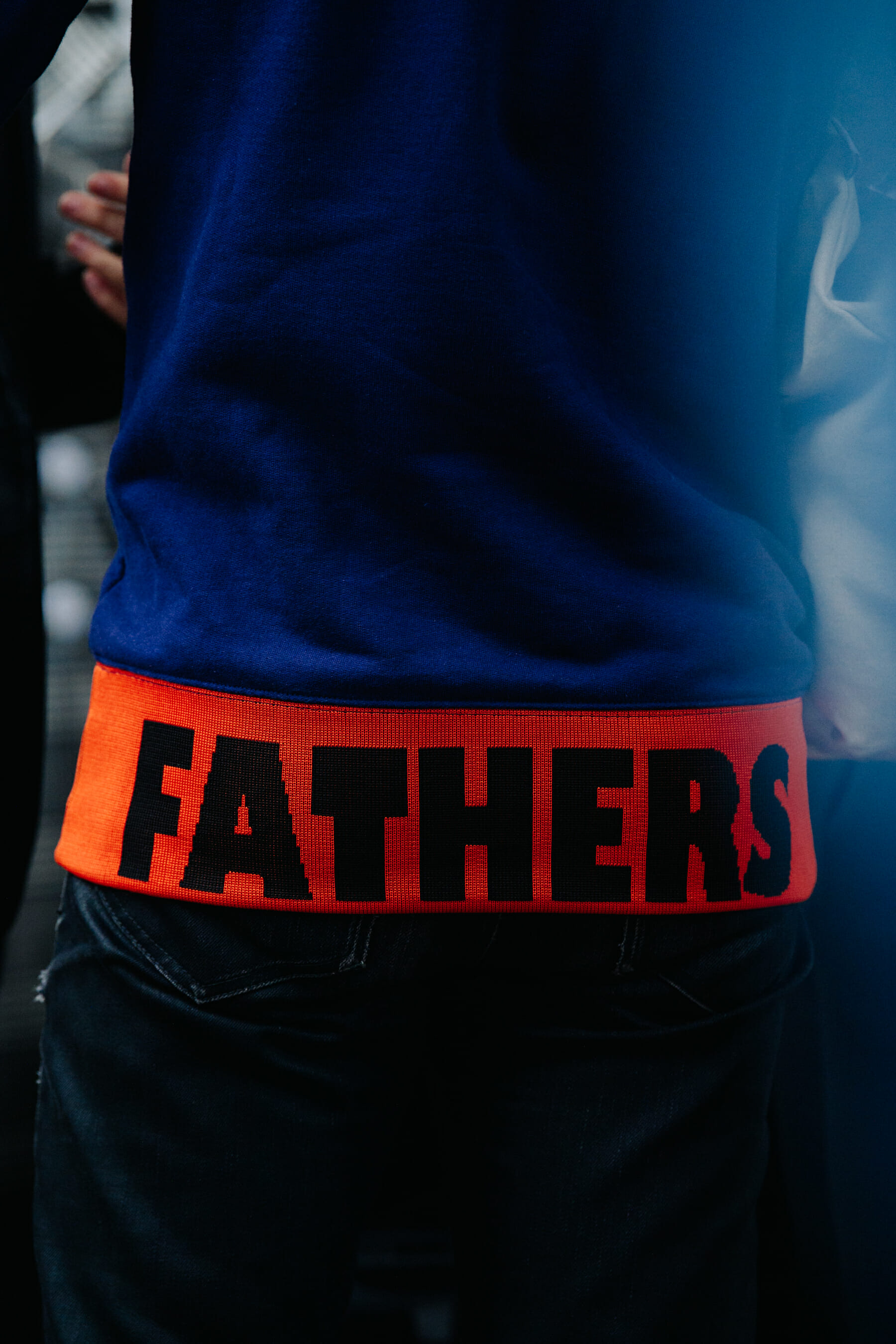 Man wearing blue and red jumper