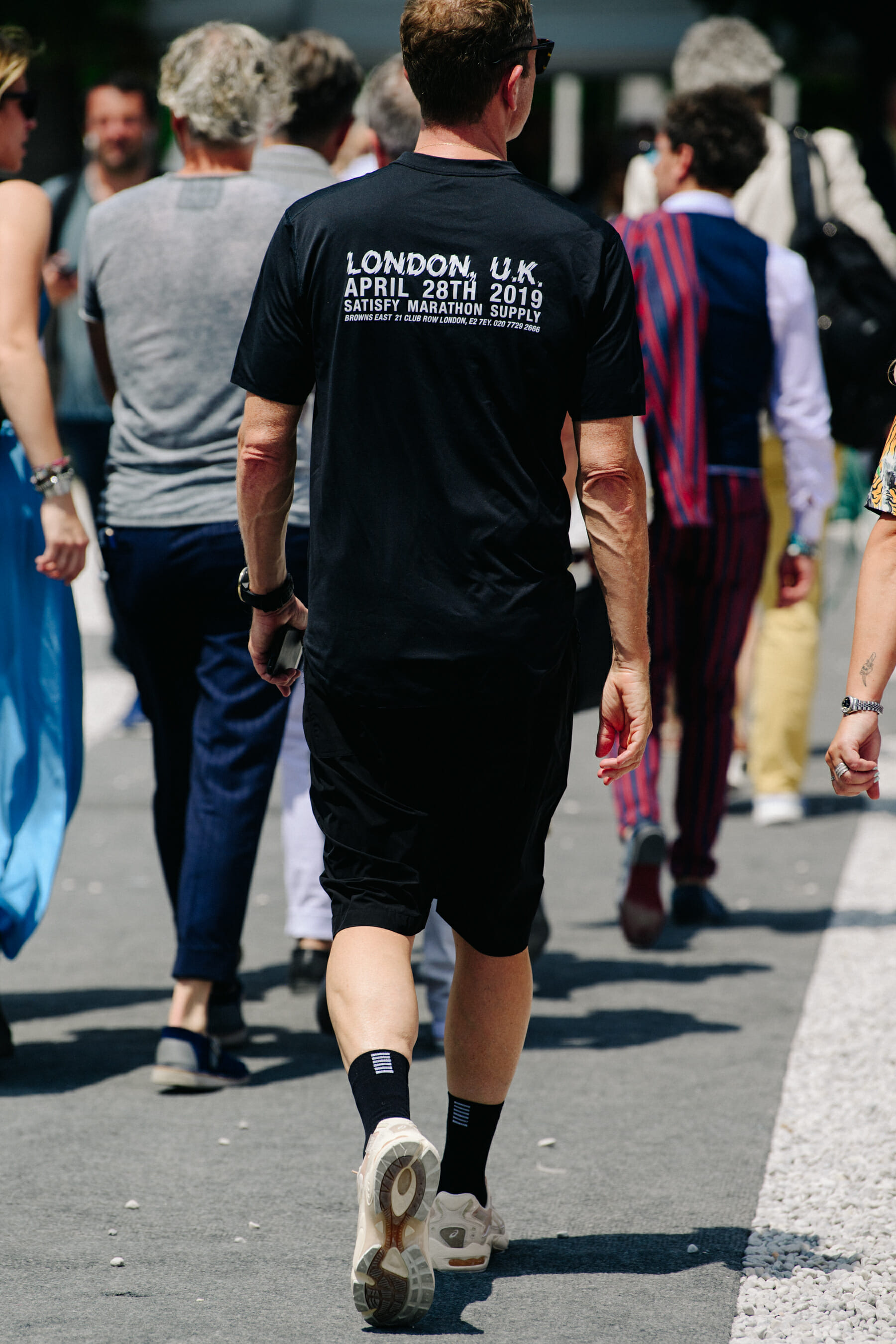 Man wearing Satisfy tee shirt
