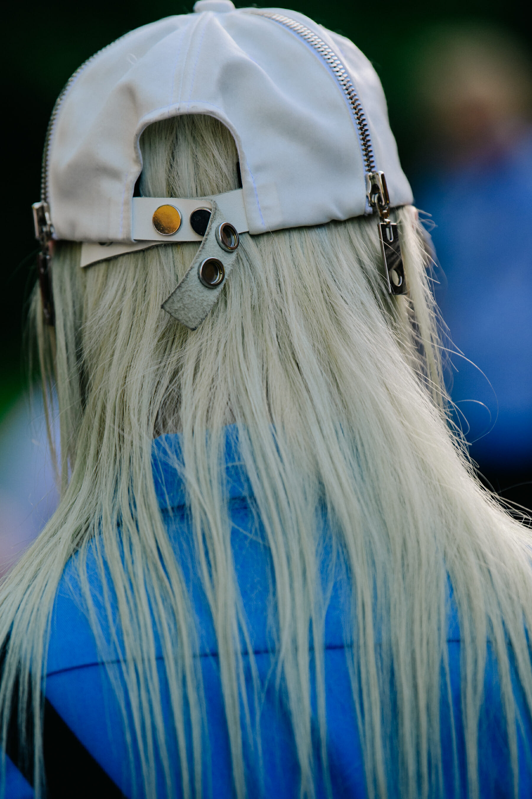 Woman wearing white leather cap