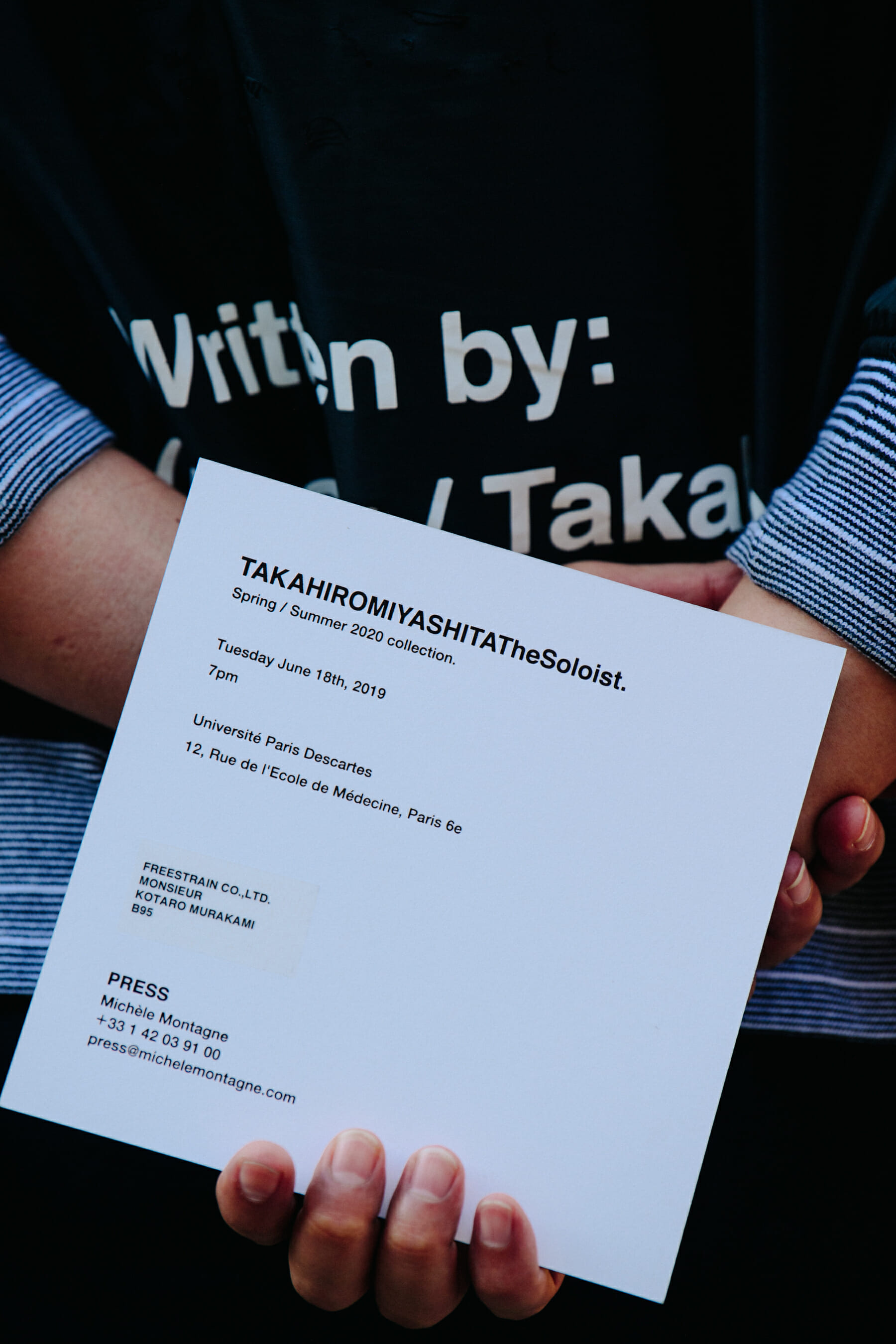 Man holding show invite