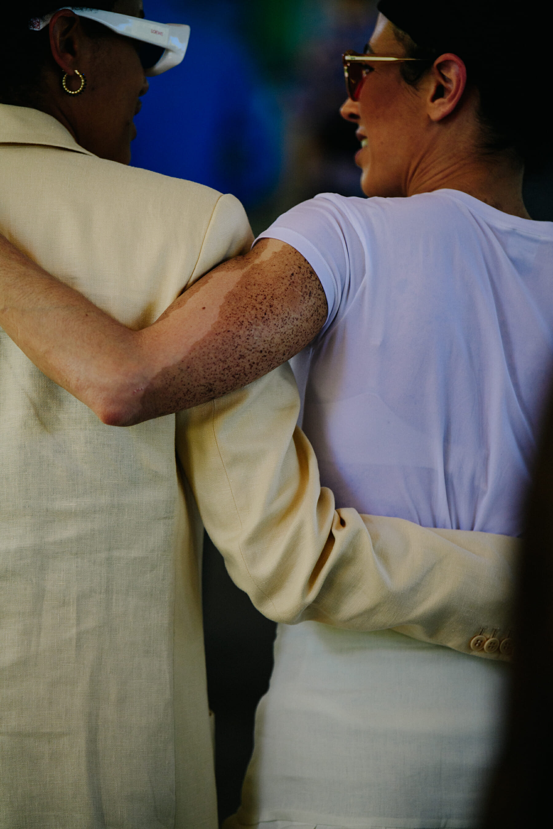 Two women wearing light colour
