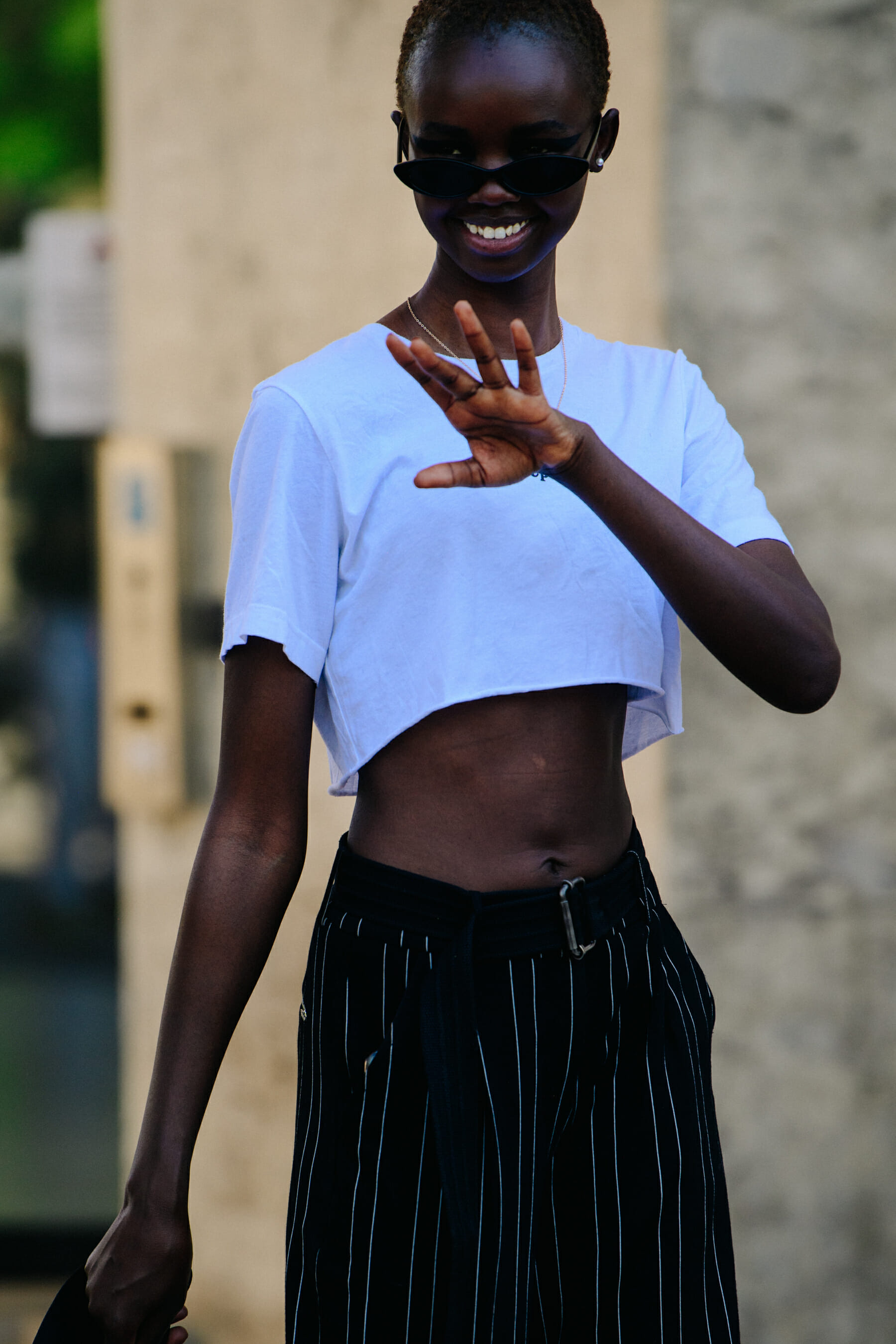 Model wearing white crop top