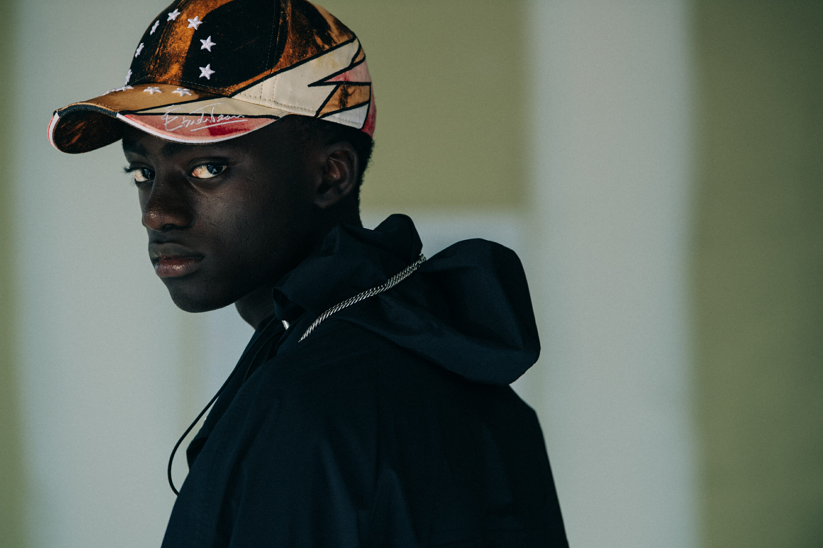 Model wearing cap at Etudes