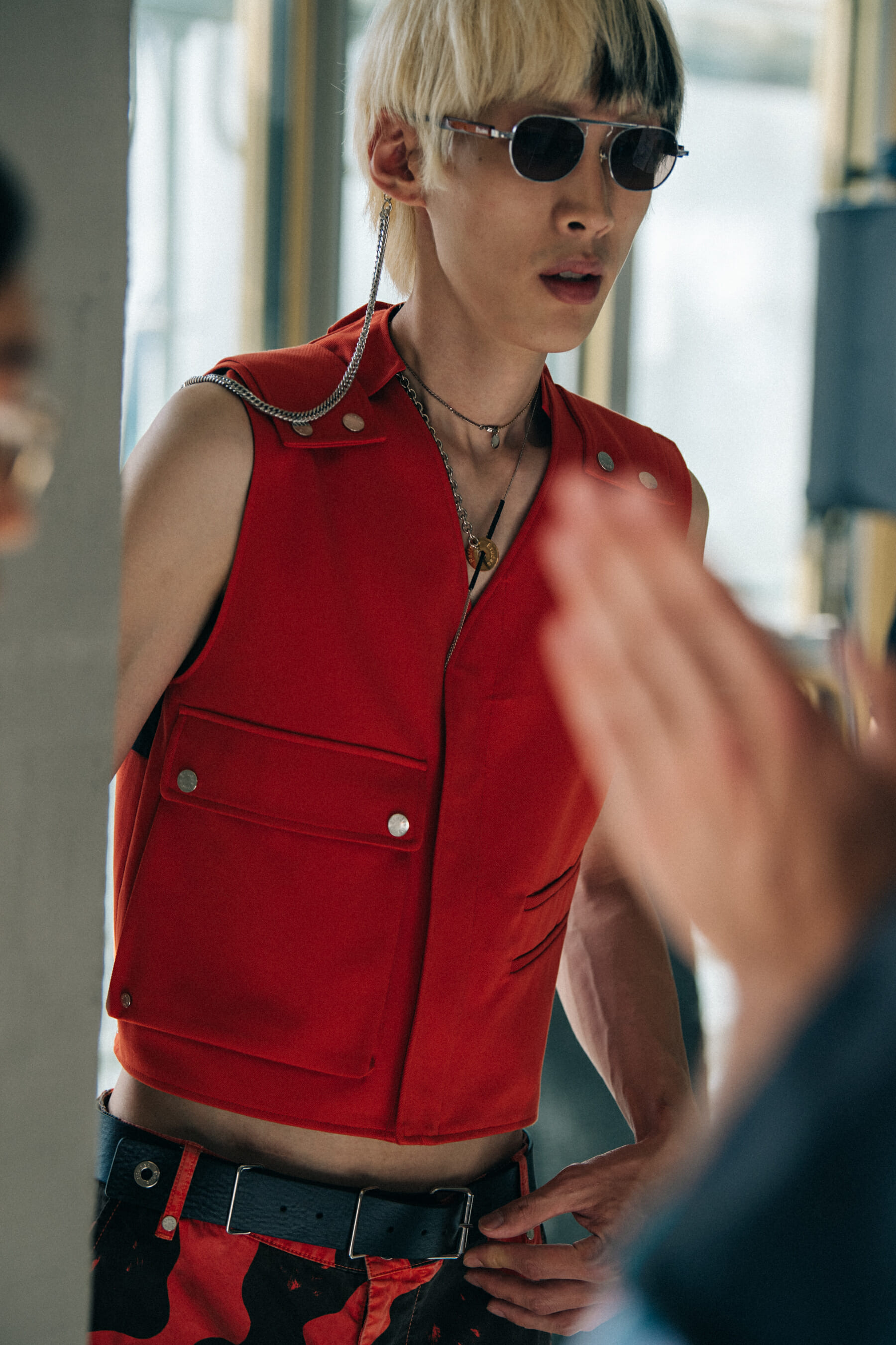 Model wearing red outfit at Etudes