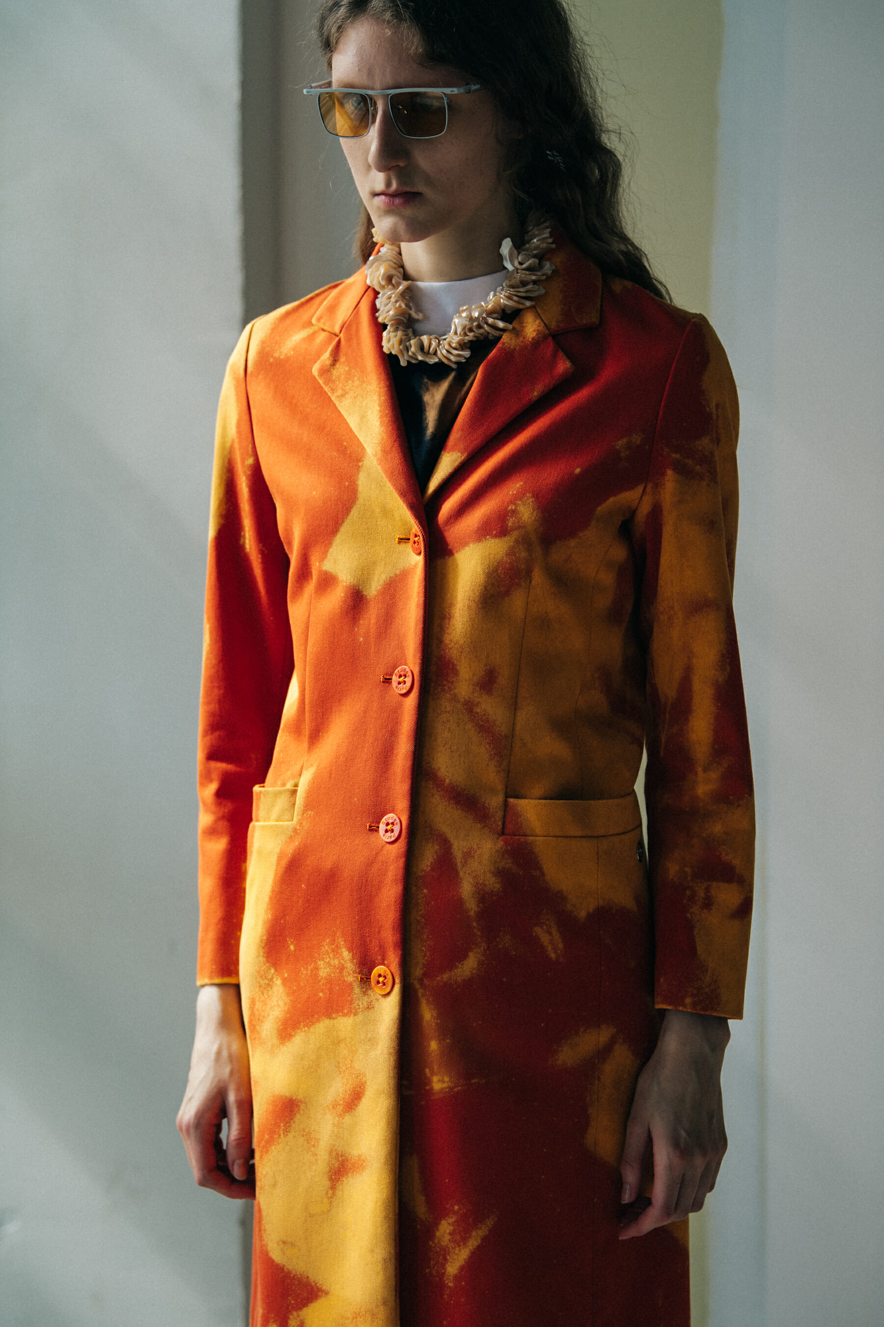 Model wearing red outfit at Etudes