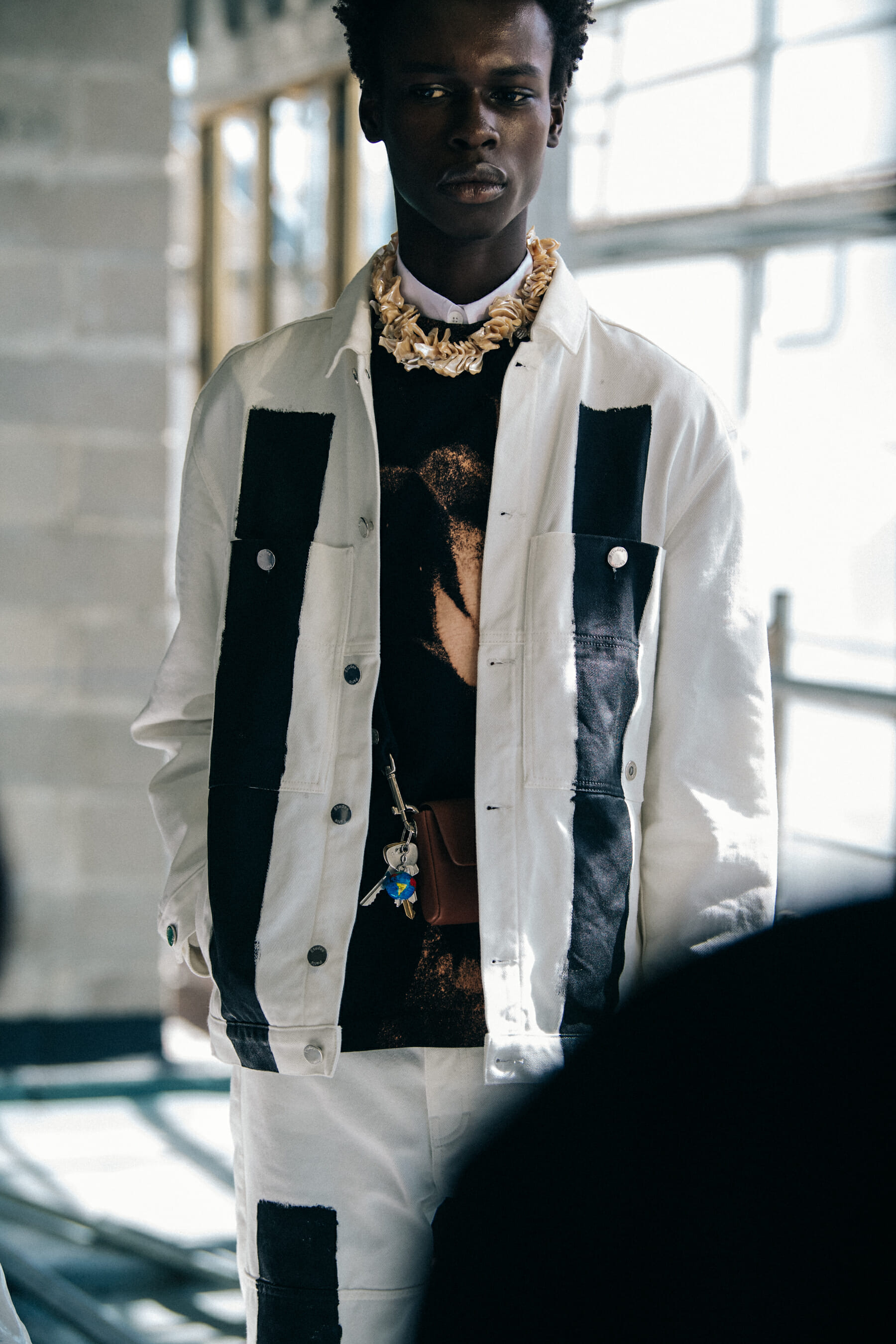 Model wearing white shirt at Etudes