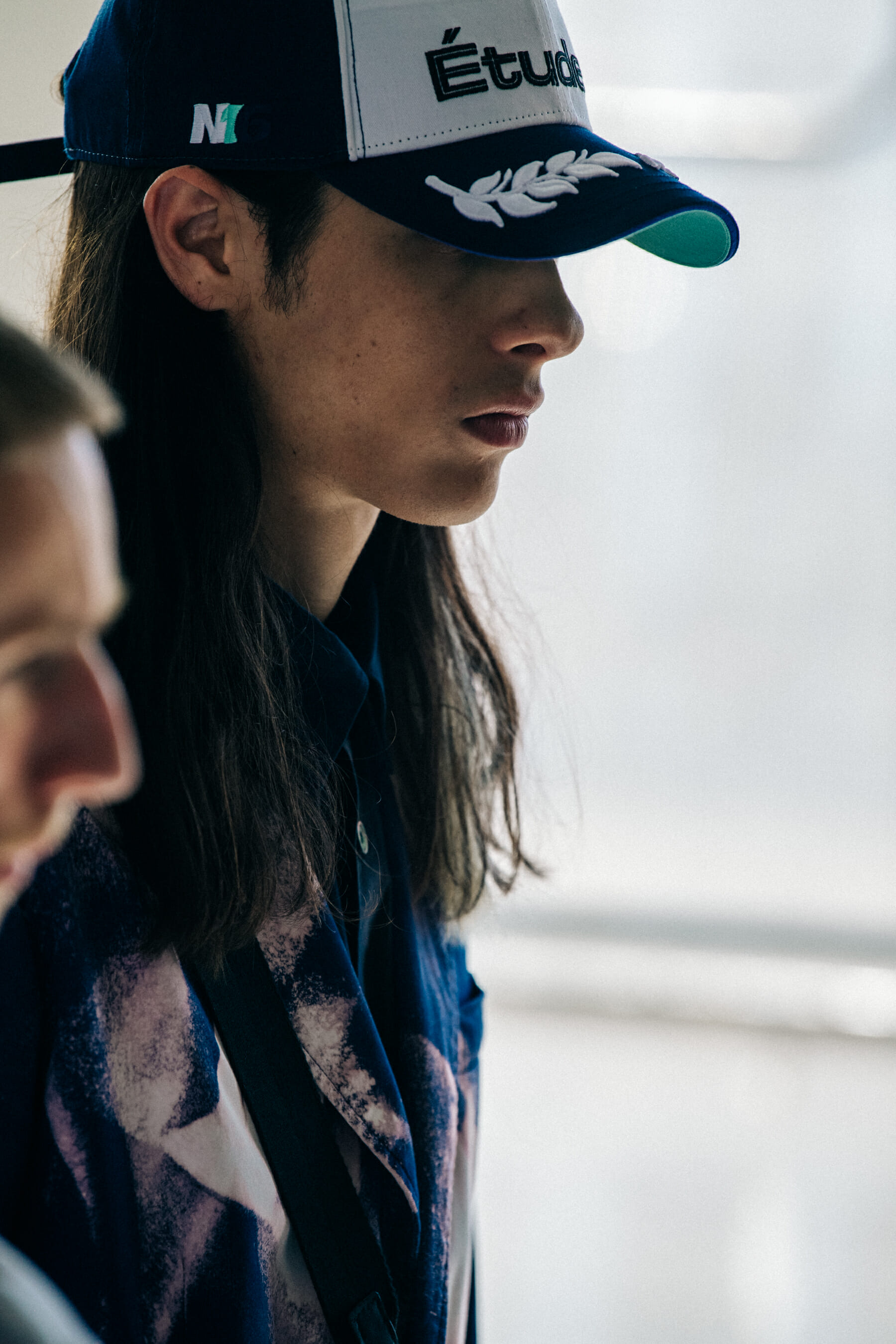 Model wearing cap at Etudes