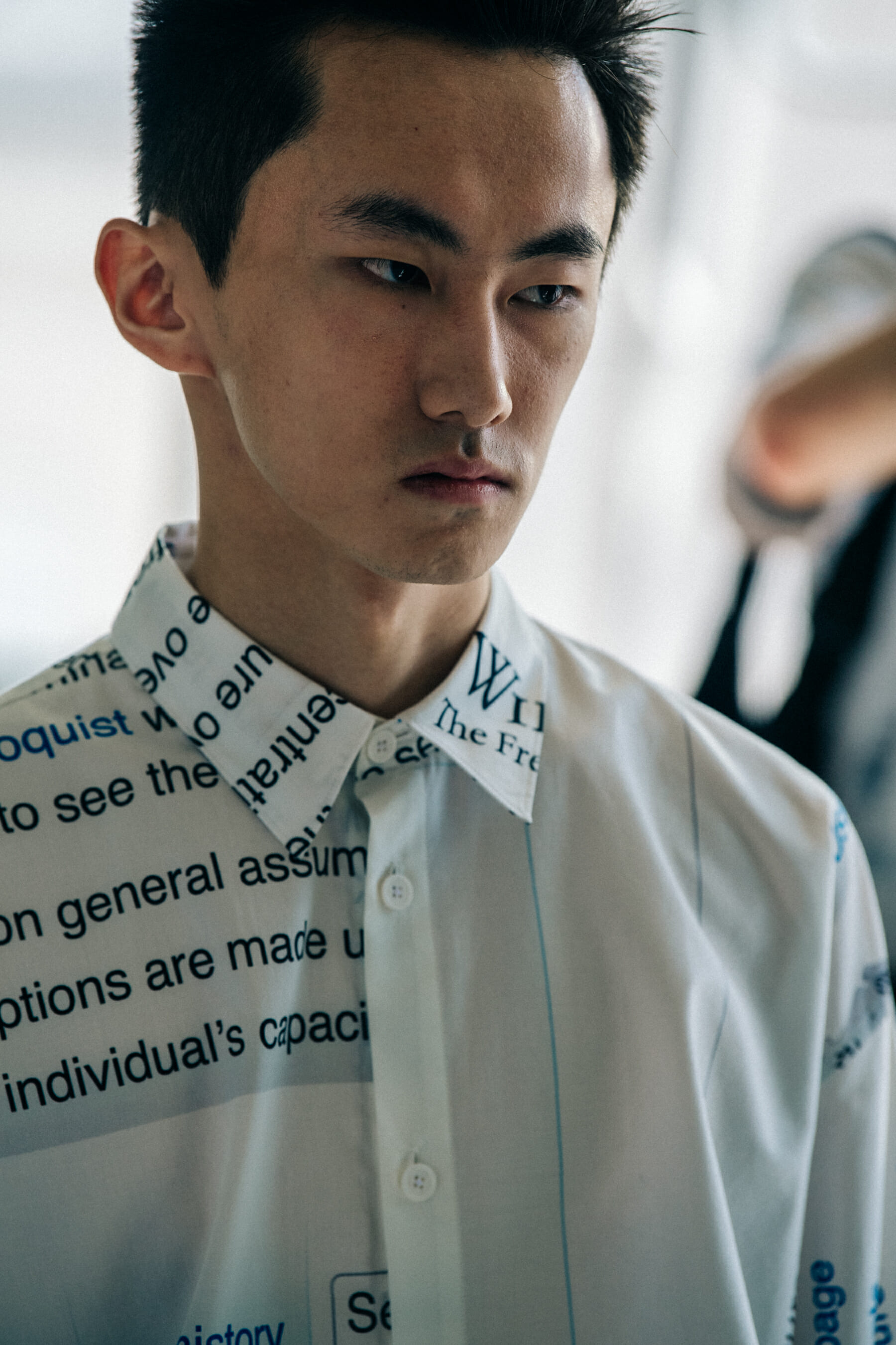 Model wearing white shirt at Etudes