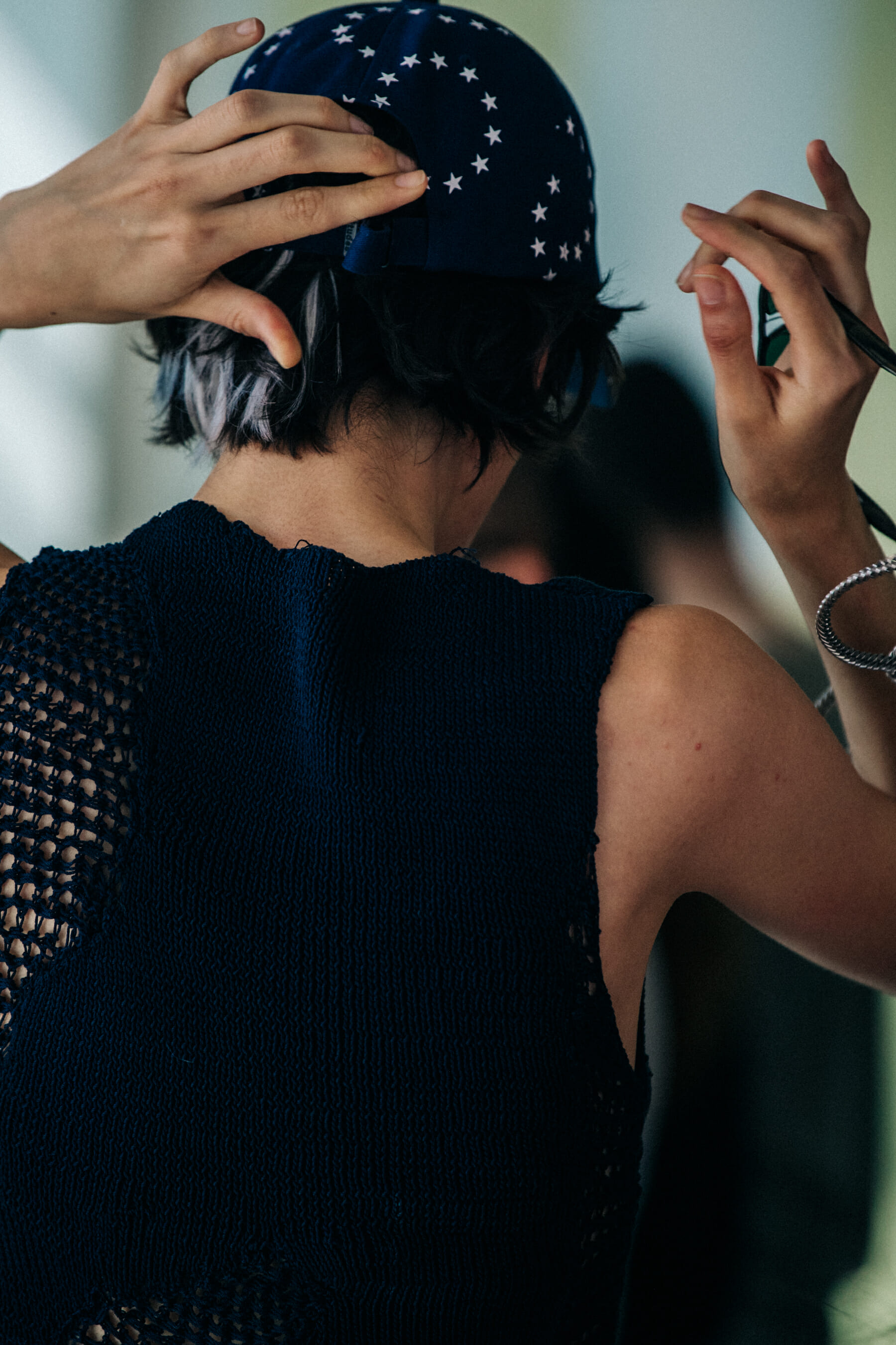 Model wearing cap at Etudes