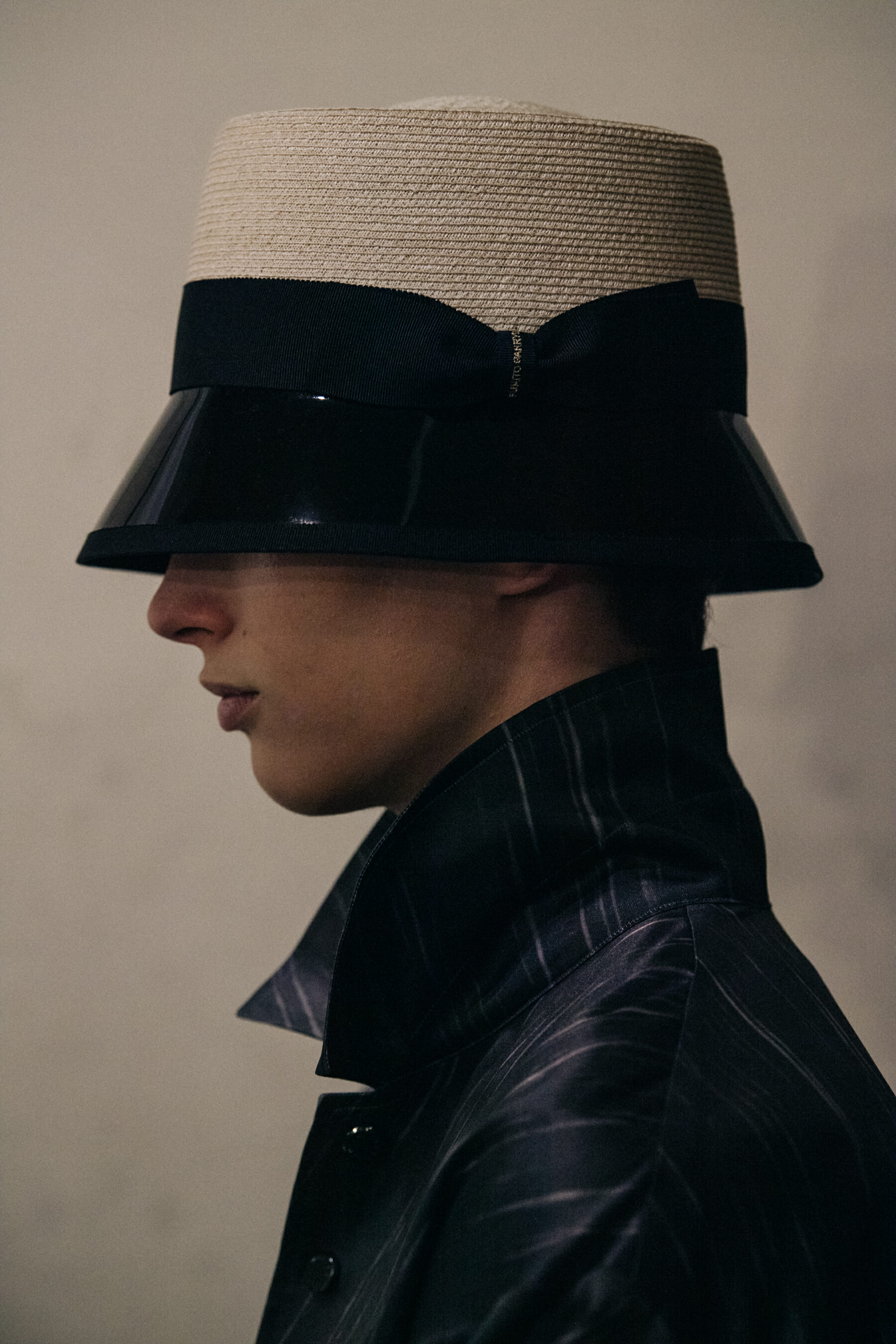 Model wearing straw hat backstage at Fumito Ganyru