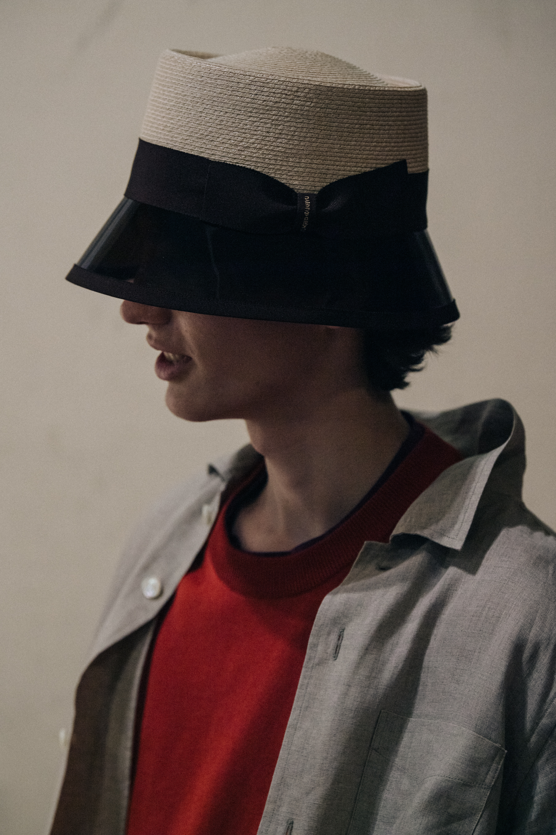 Model wearing straw hat backstage at Fumito Ganyru