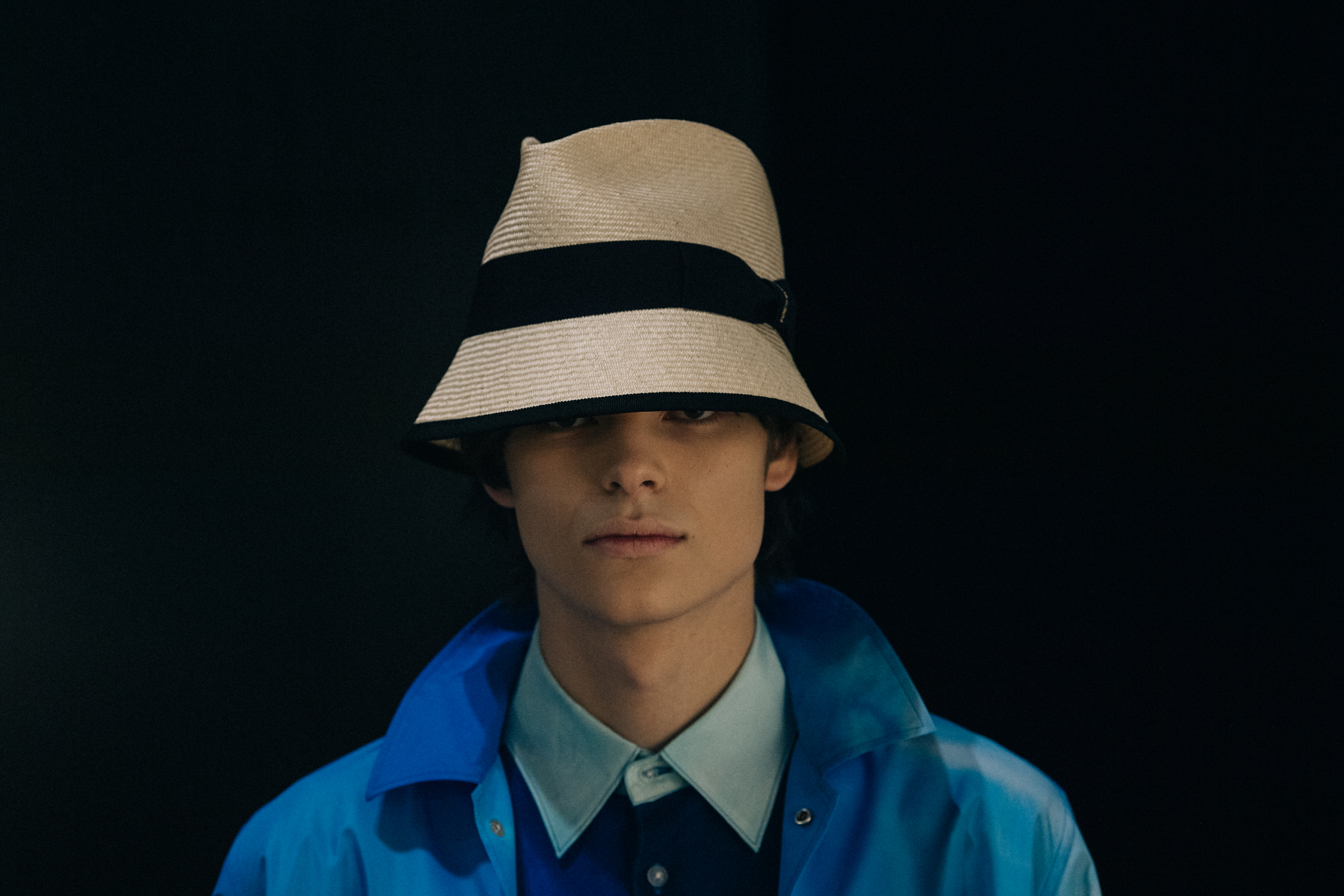 Model wearing straw hat backstage at Fumito Ganyru