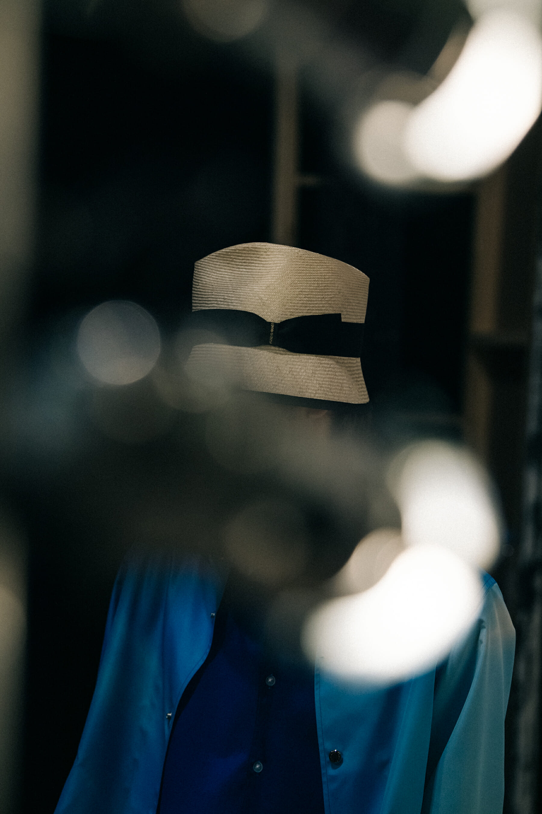 Model wearing straw hat backstage at Fumito Ganyru