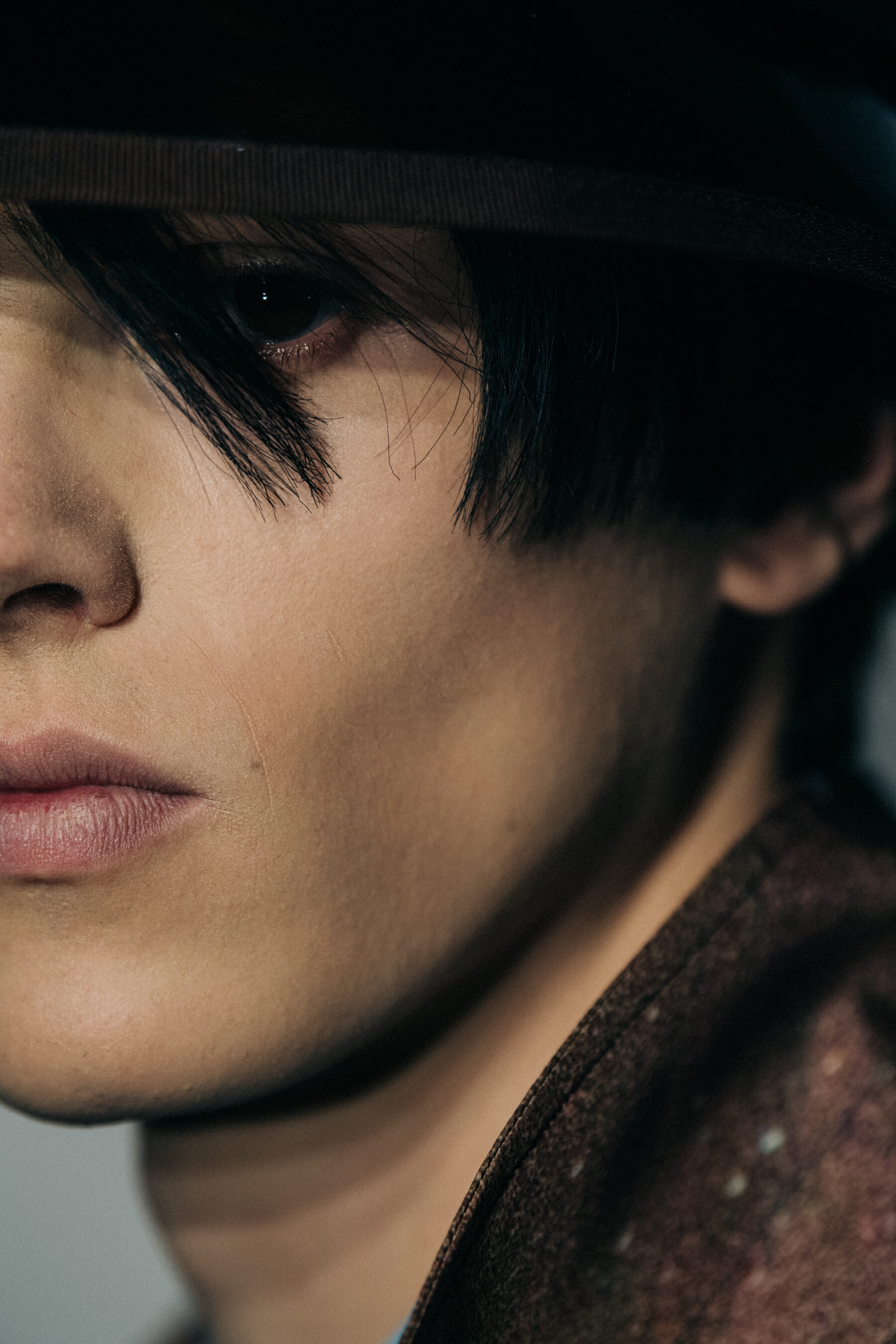 Model wearing straw hat backstage at Fumito Ganyru