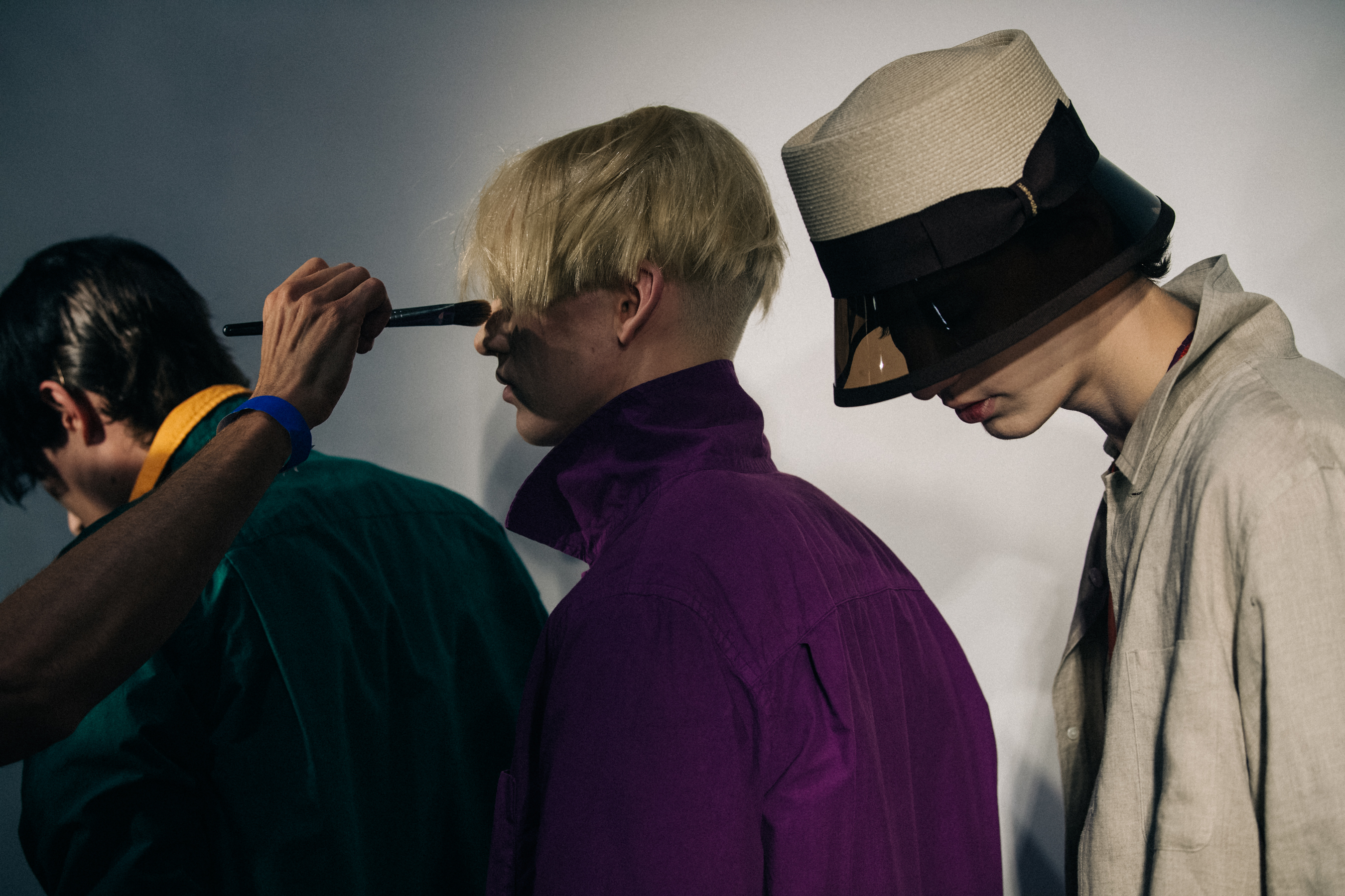 Model wearing straw hat backstage at Fumito Ganyru